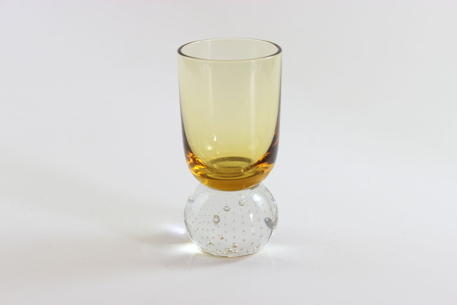 Set of amber pinched glass decanter and six glasses on a white background