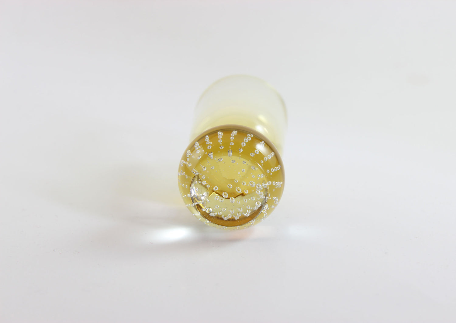 Set of amber pinched glass decanter and six glasses on a white background