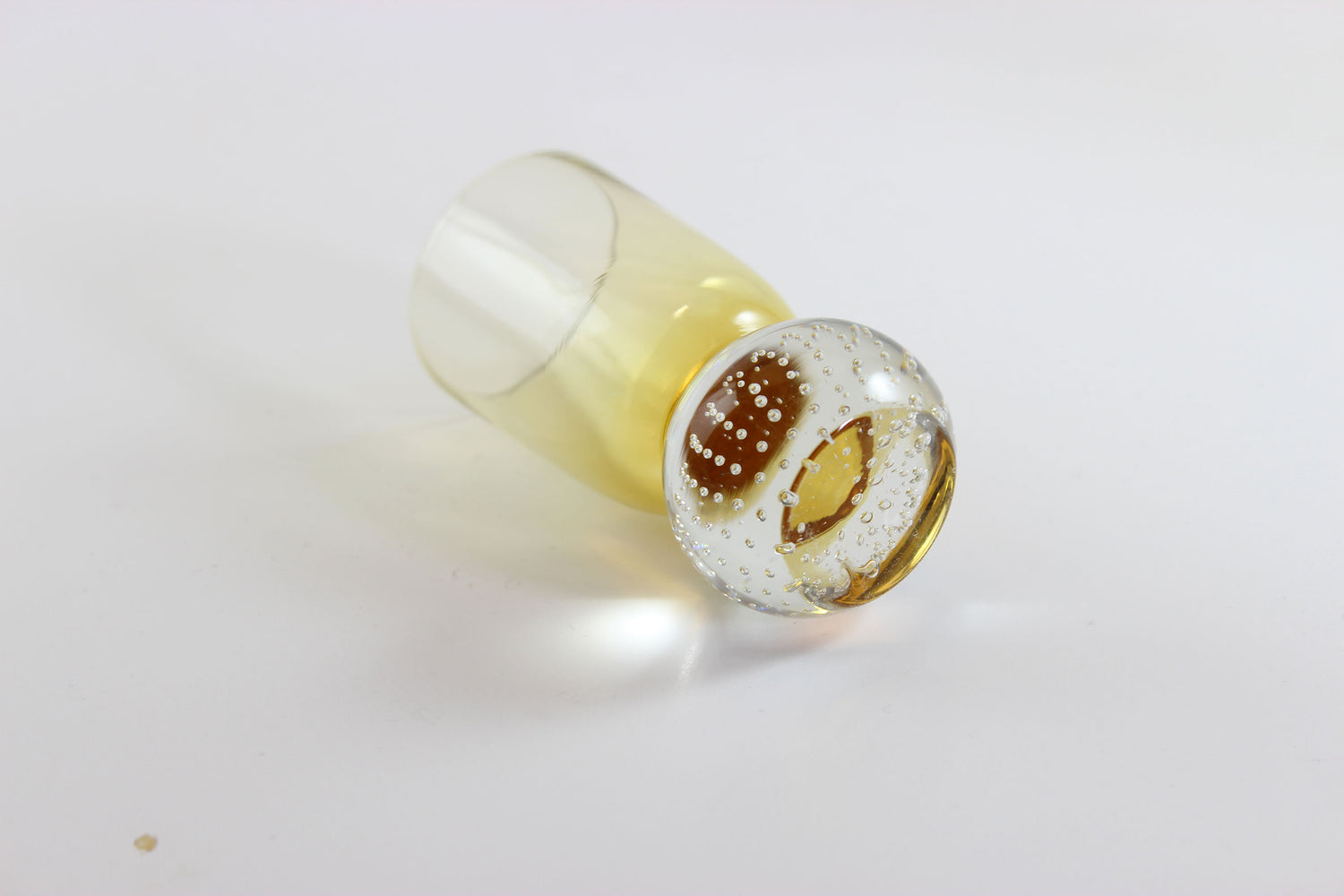 Set of amber pinched glass decanter and six glasses on a white background