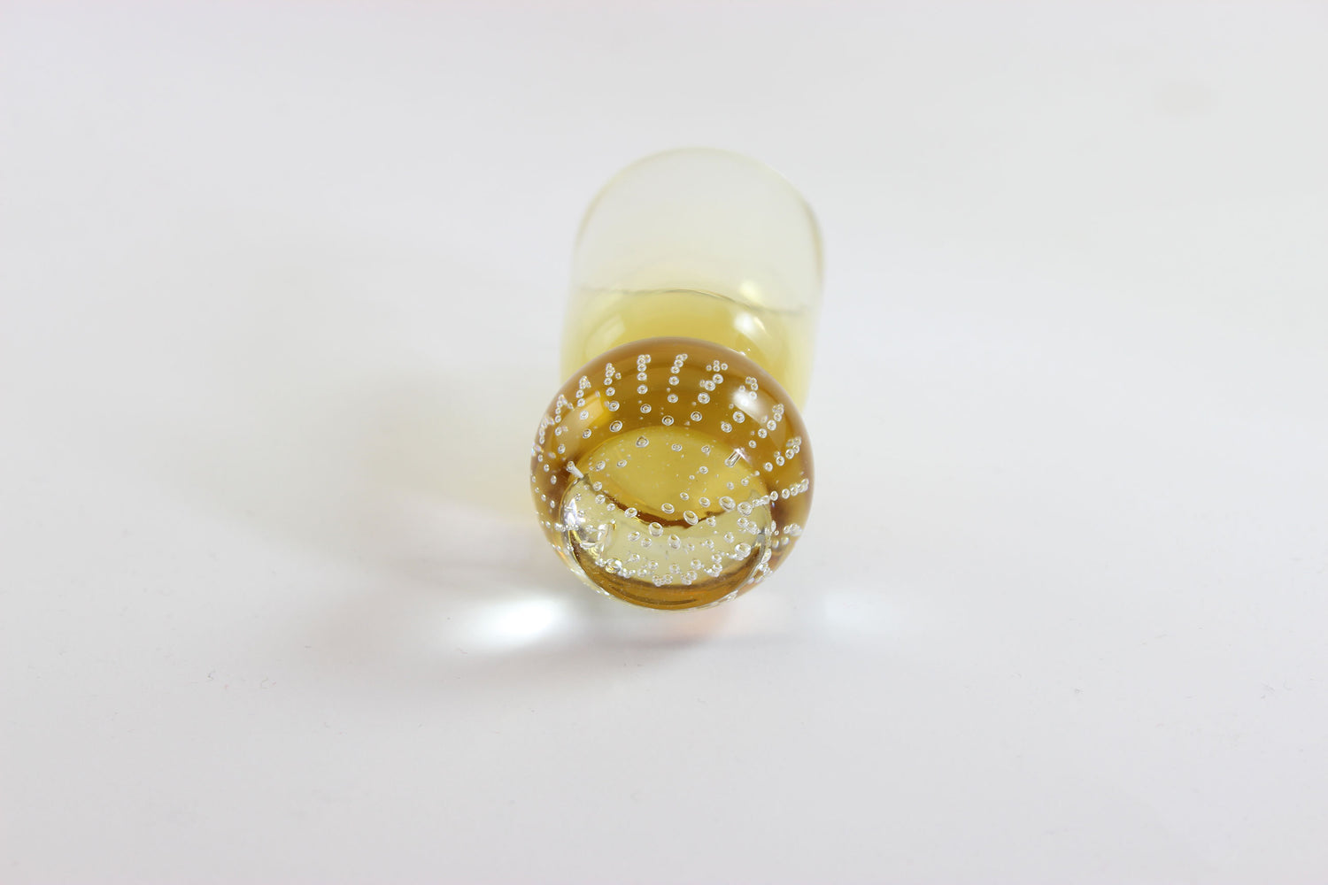 Set of amber pinched glass decanter and six glasses on a white background