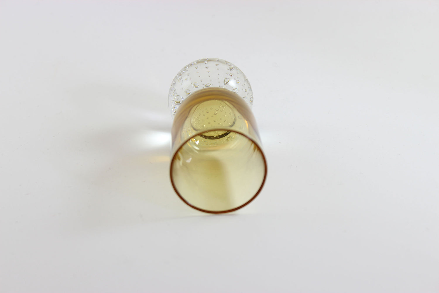 Set of amber pinched glass decanter and six glasses on a white background