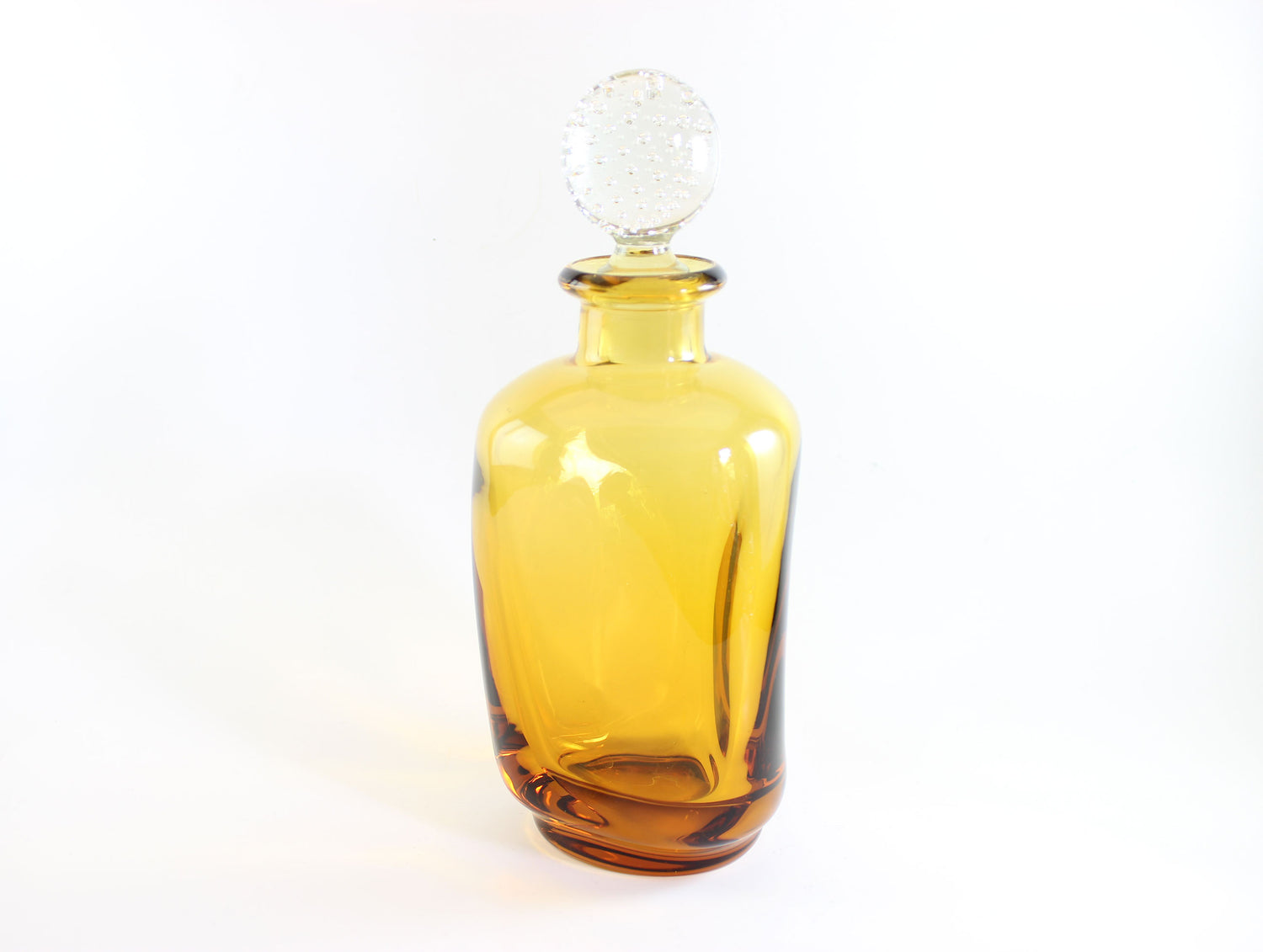 Set of amber pinched glass decanter and six glasses on a white background