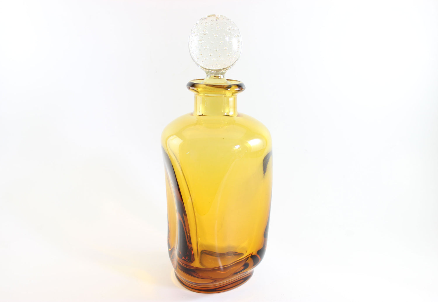 Set of amber pinched glass decanter and six glasses on a white background