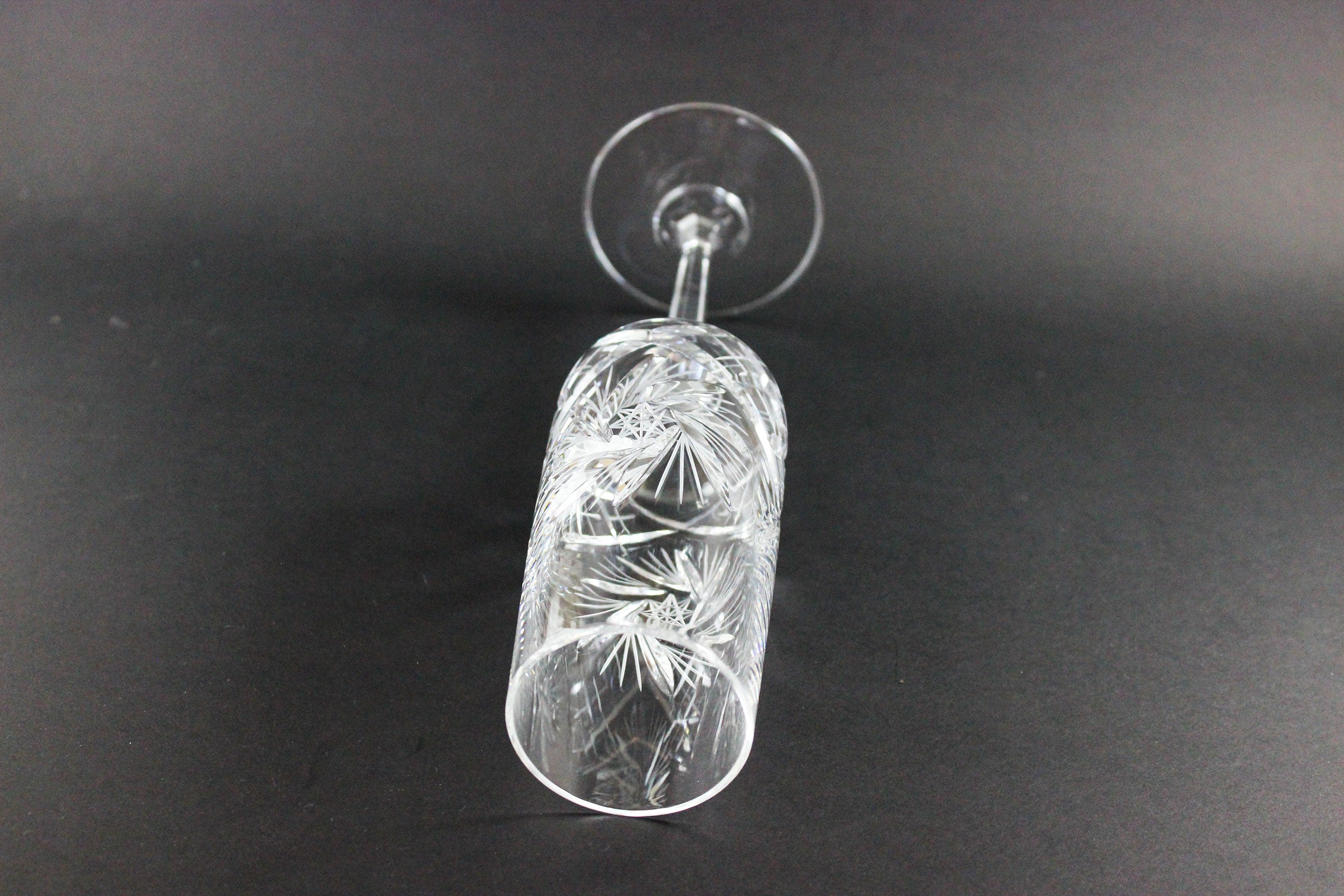 Crystal champagne flute with cut pinwheel design on a black background