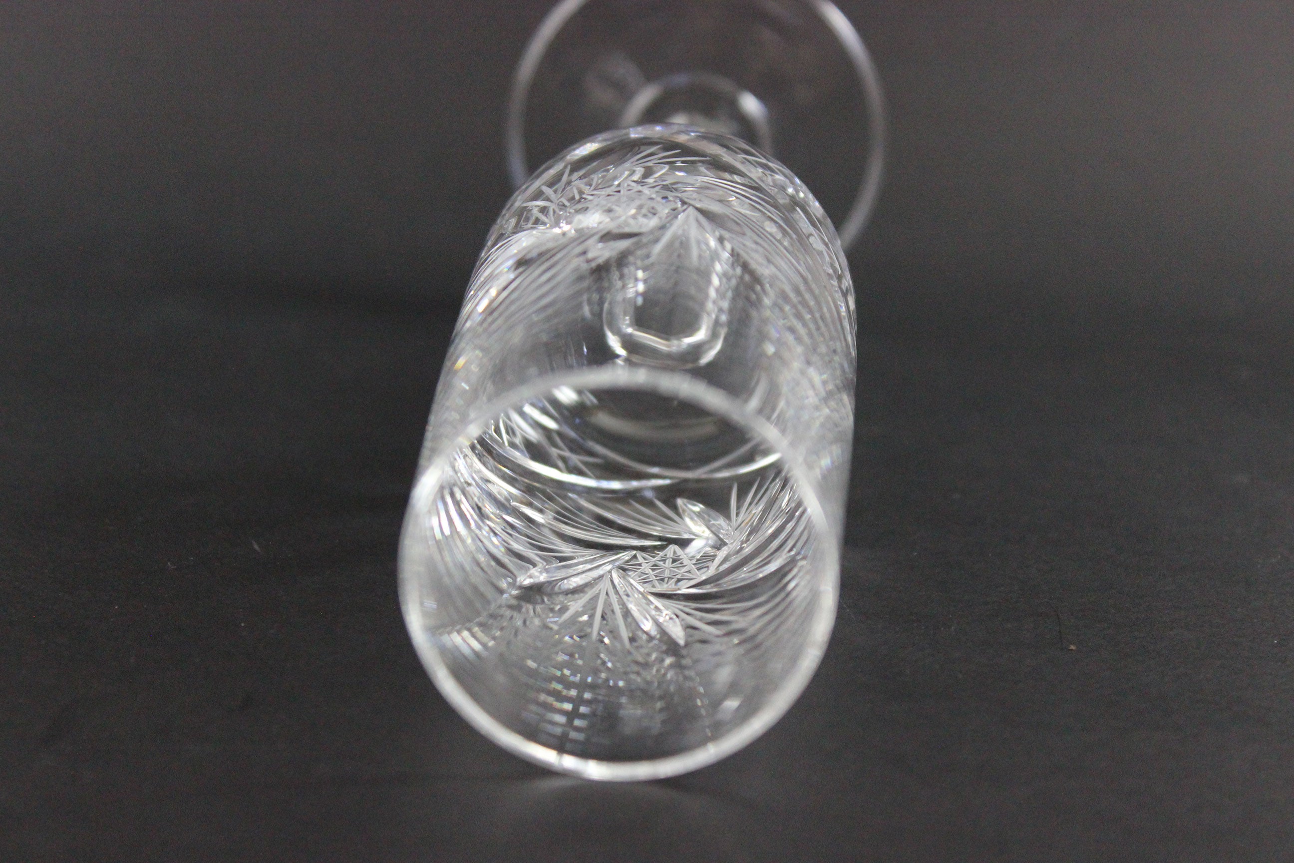 Crystal champagne flute with cut pinwheel design on a black background
