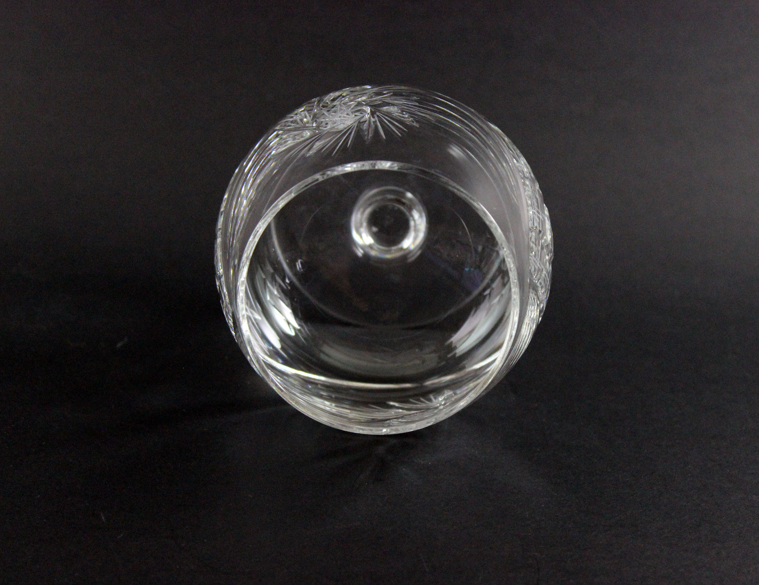 Clear crystal glass with intricate designs on a black background