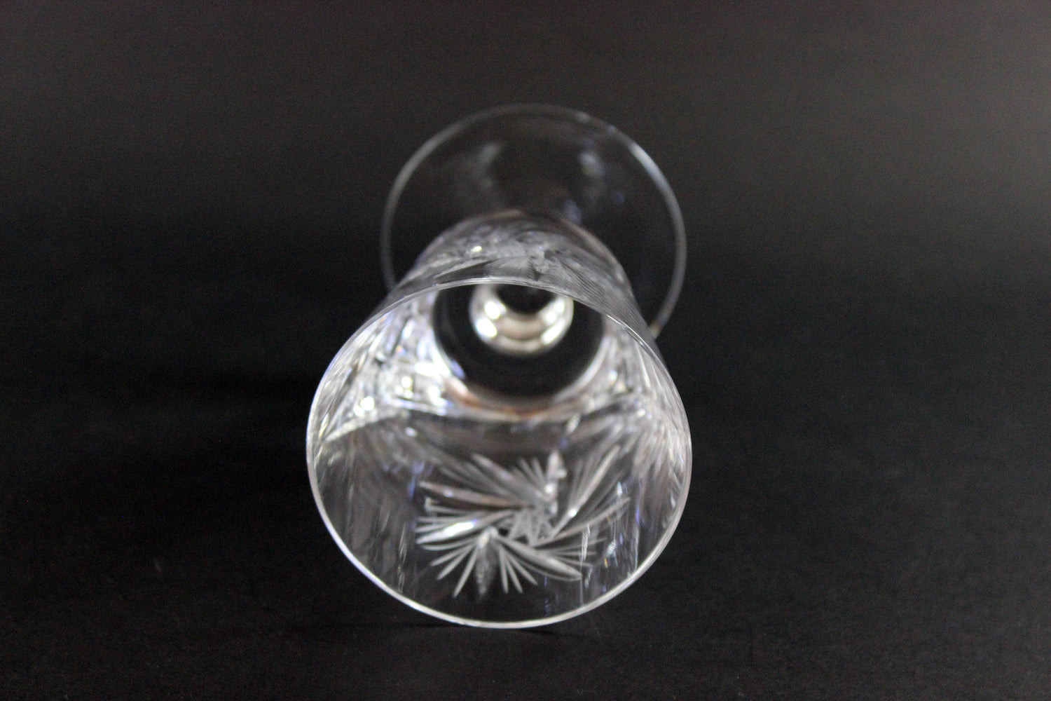 Crystal glass with cut patterns on a black background