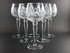 Set of six crystal wine glasses on a dark background