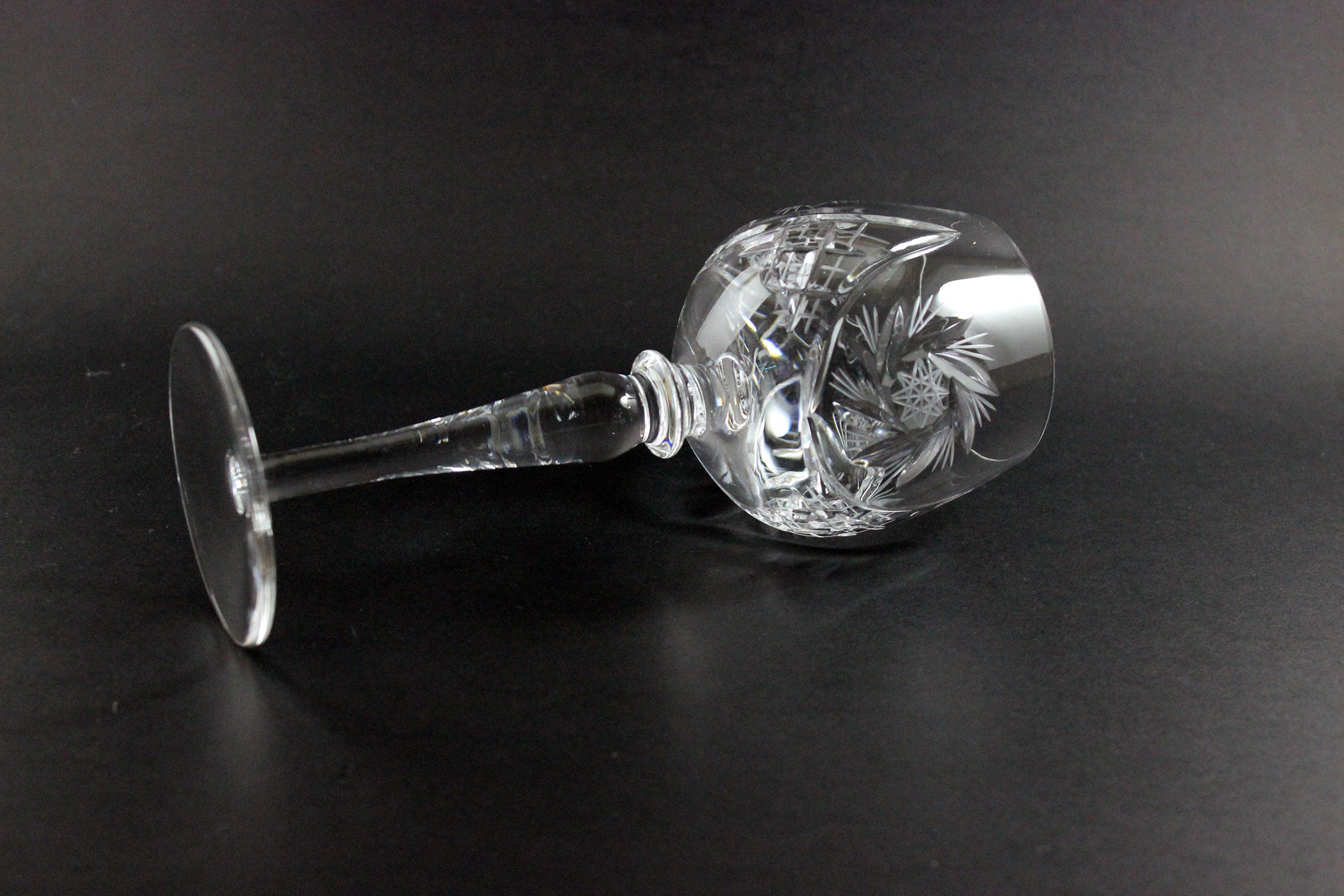 Crystal wine goblet with cut design on a black background