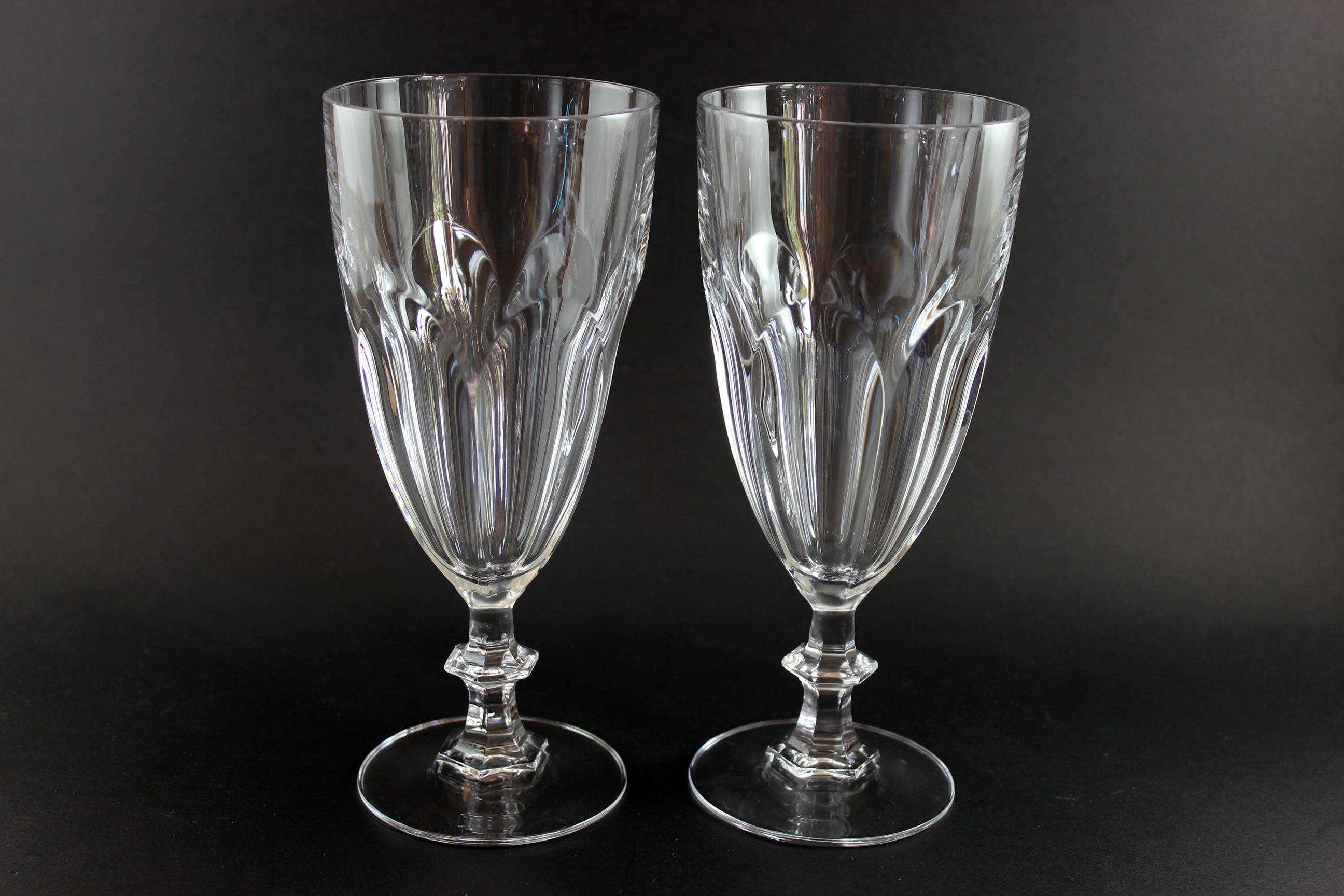 Two clear crystal goblets on a black background