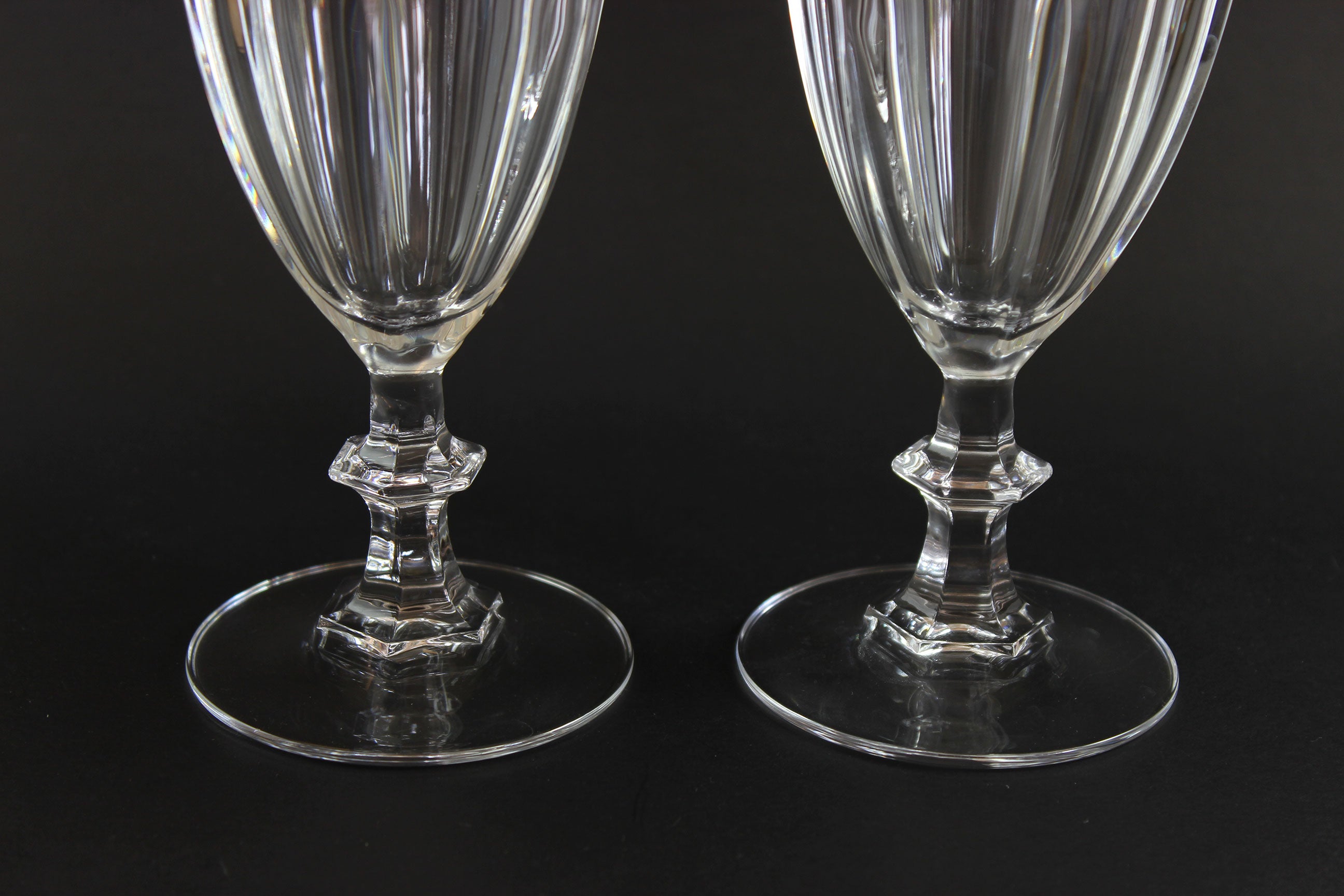 Two clear crystal goblets on a black background