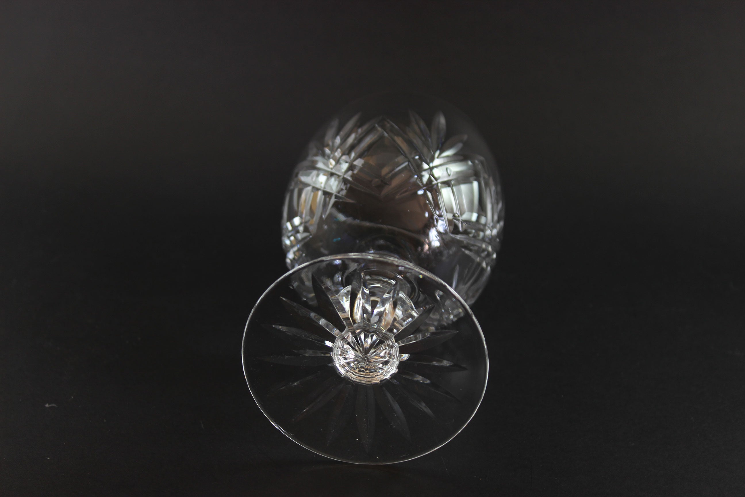 Crystal glass with cut patterns on a black background