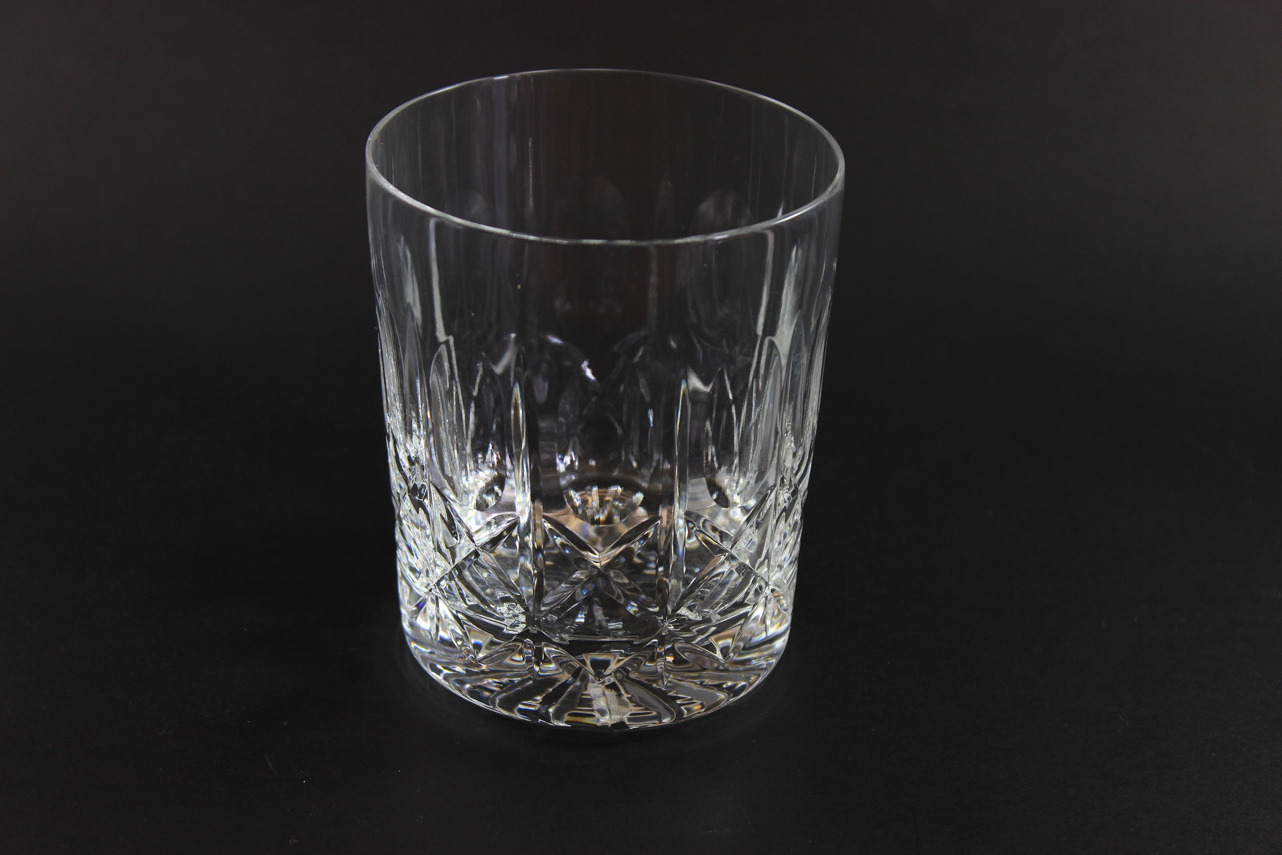 Crystal glass tumbler on a black background
