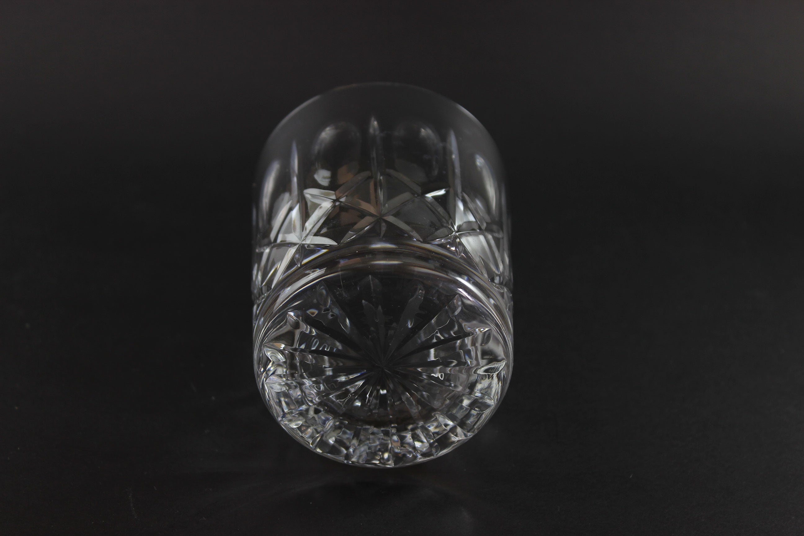 Crystal glass with cut patterns on a black background