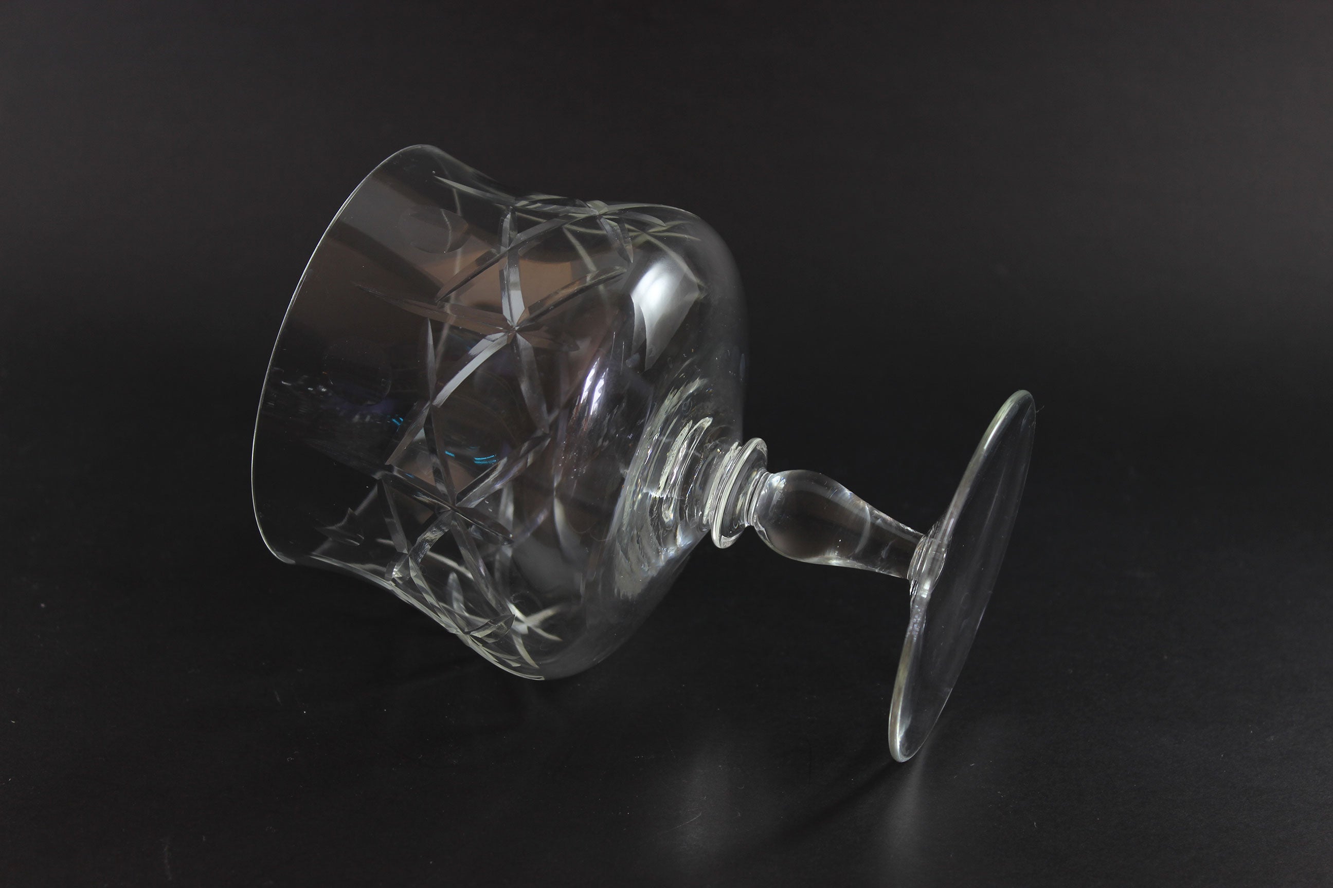 Clear crystal goblet with cross and olive cut pattern on a dark background