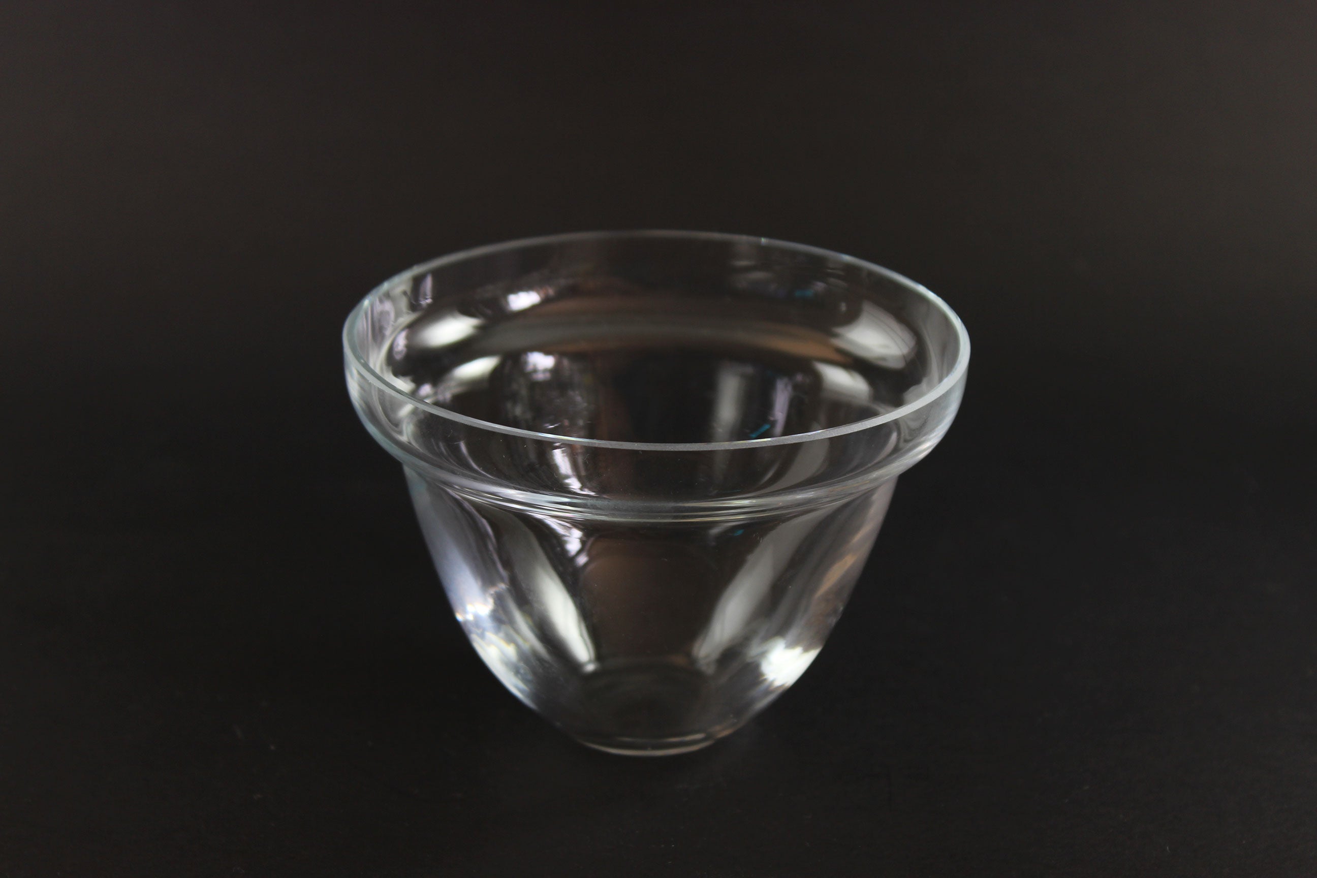Clear insert bowl on a black background