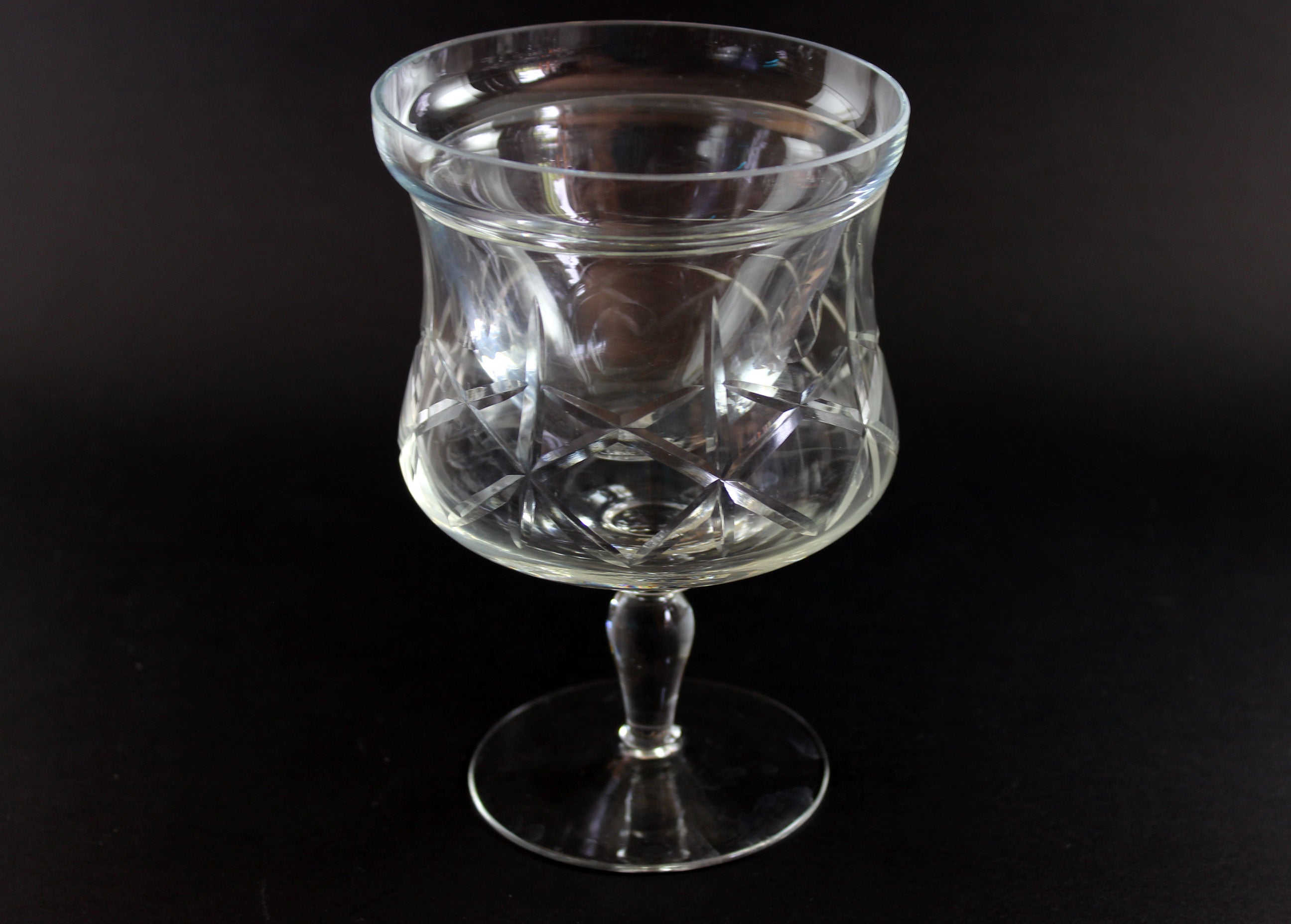 Clear glass goblet on a black background
