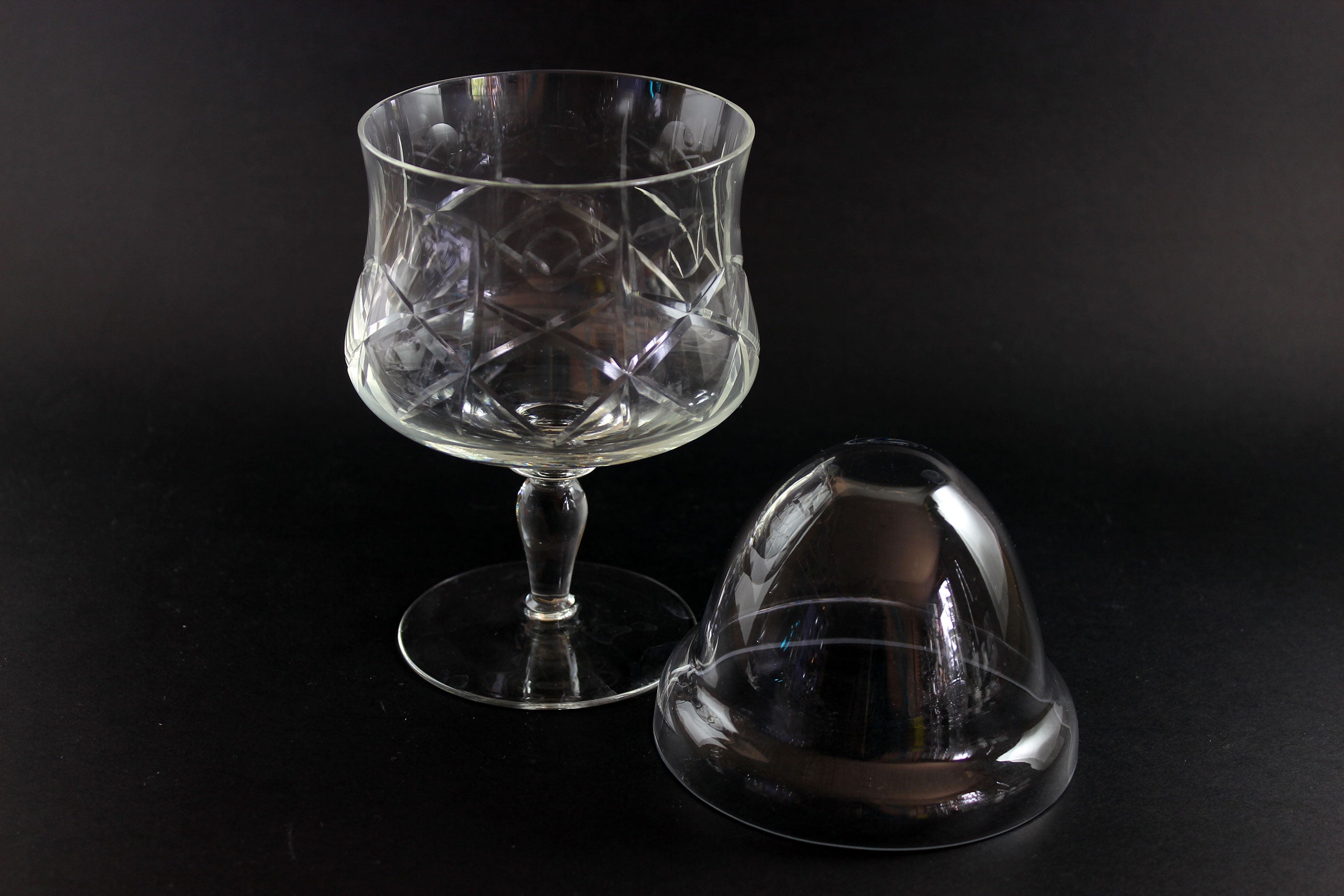 Clear crystal goblet with cross and olive cut pattern on a dark background and clear glass insert