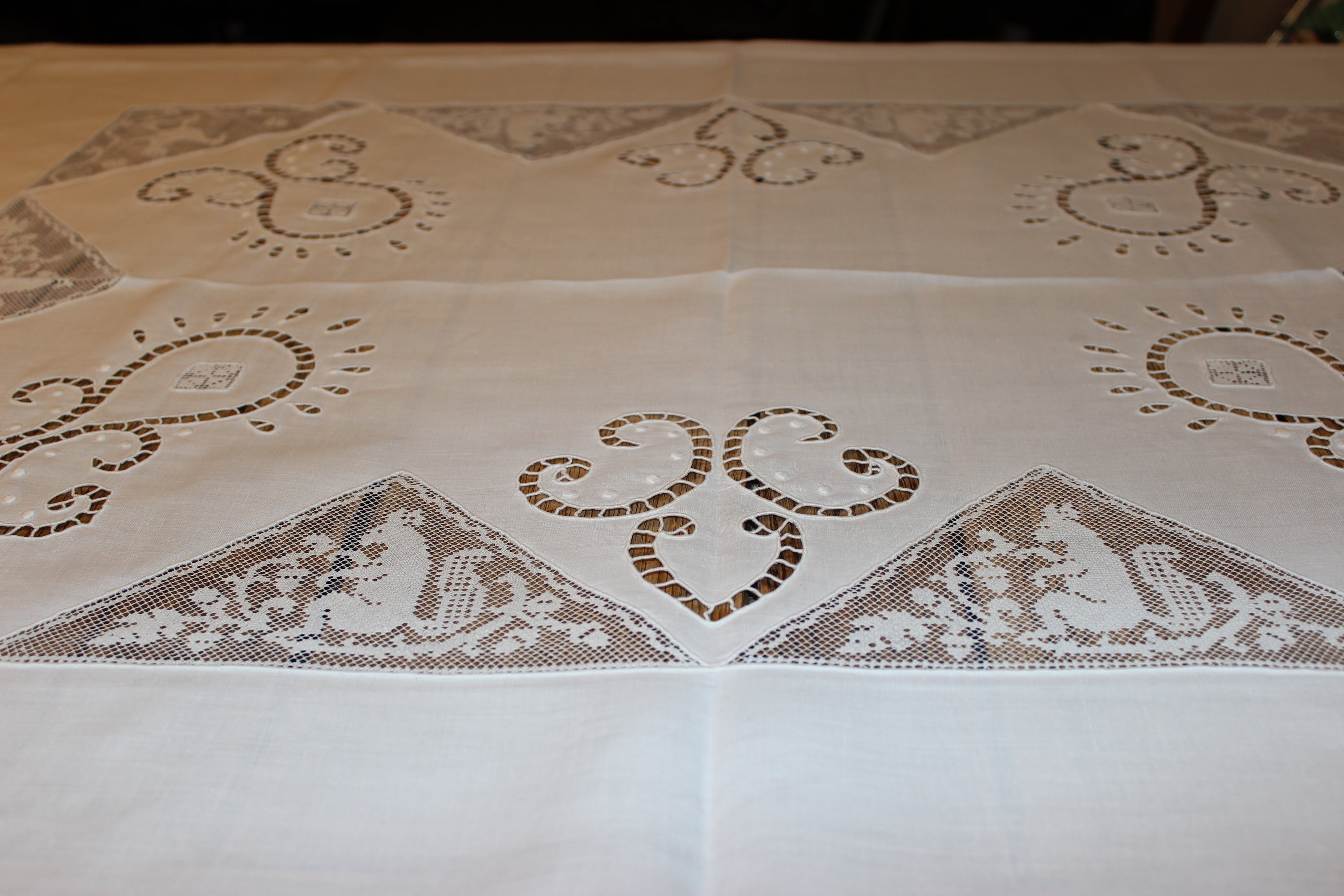 Decorative tablecloth with intricate lace patterns on a plain background