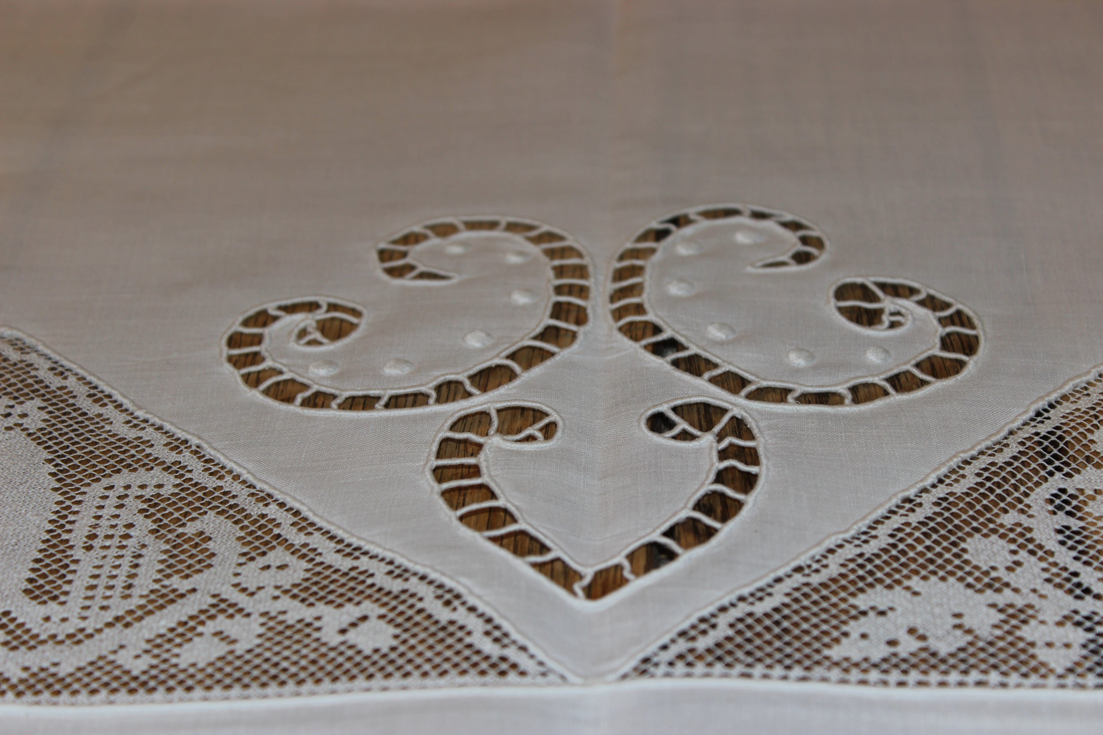 Lace tablecloth with intricate heart design on a beige background