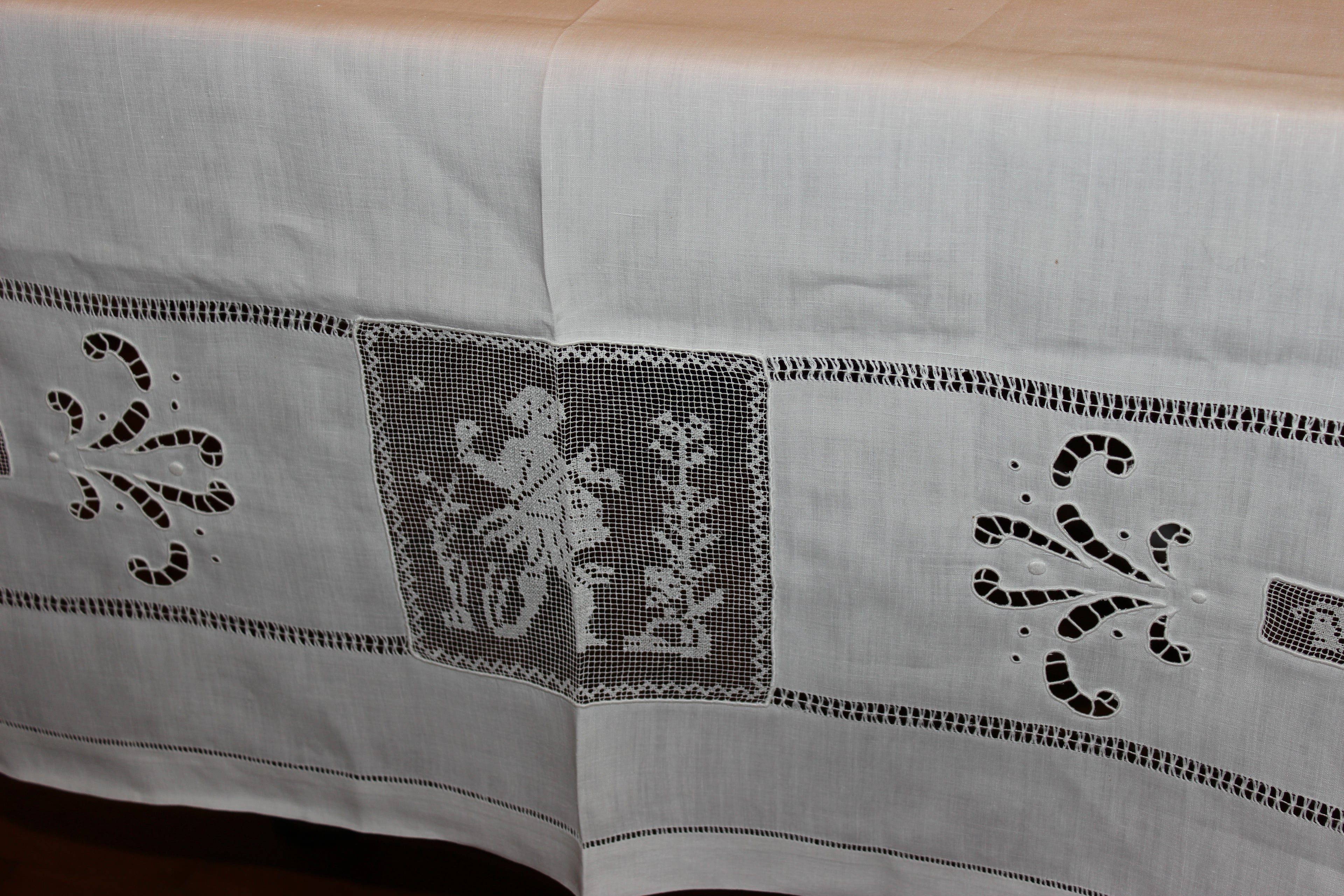 Embroidered tablecloth with decorative patterns on a wooden surface