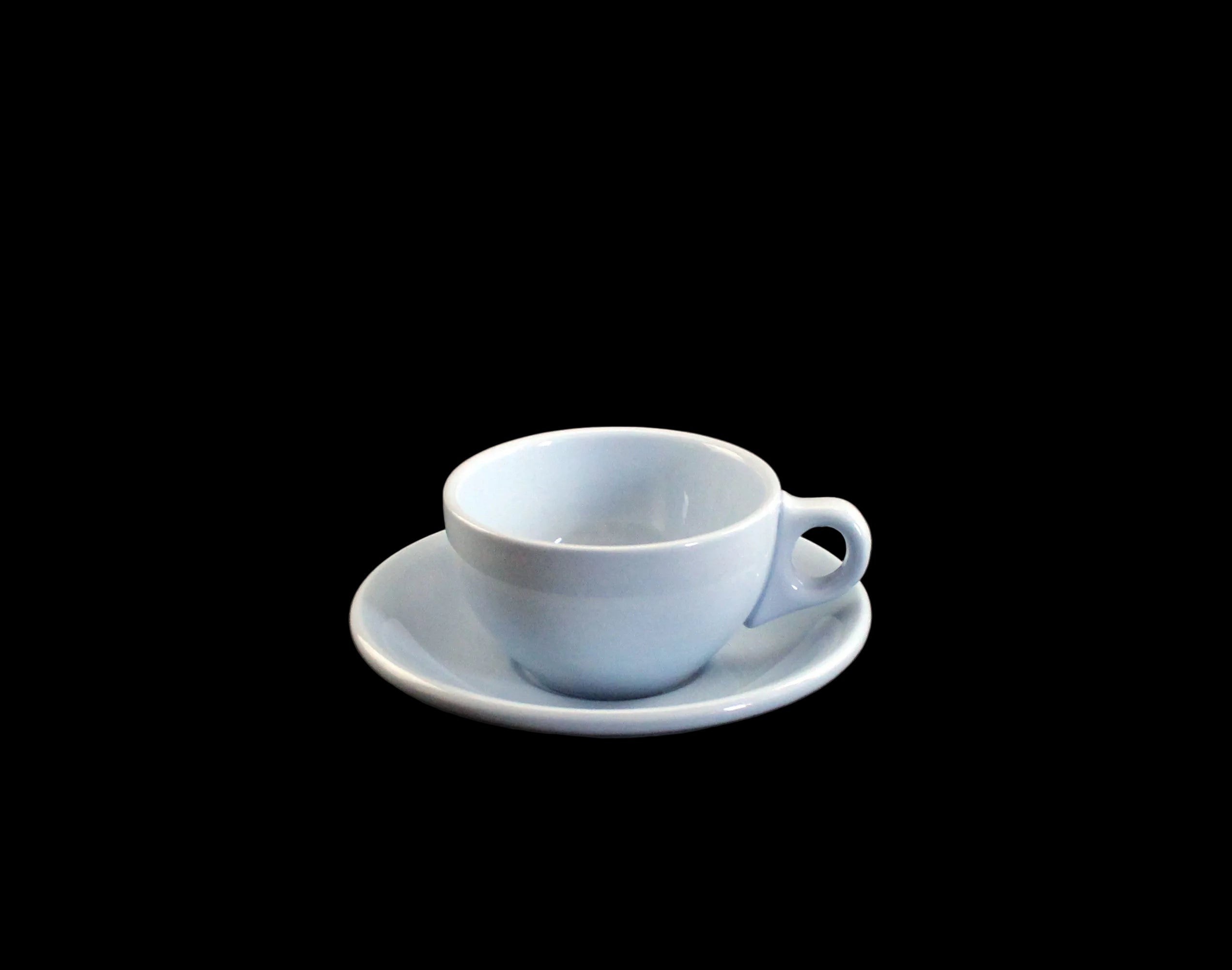 Light blue ceramic cup and saucer on a dark background