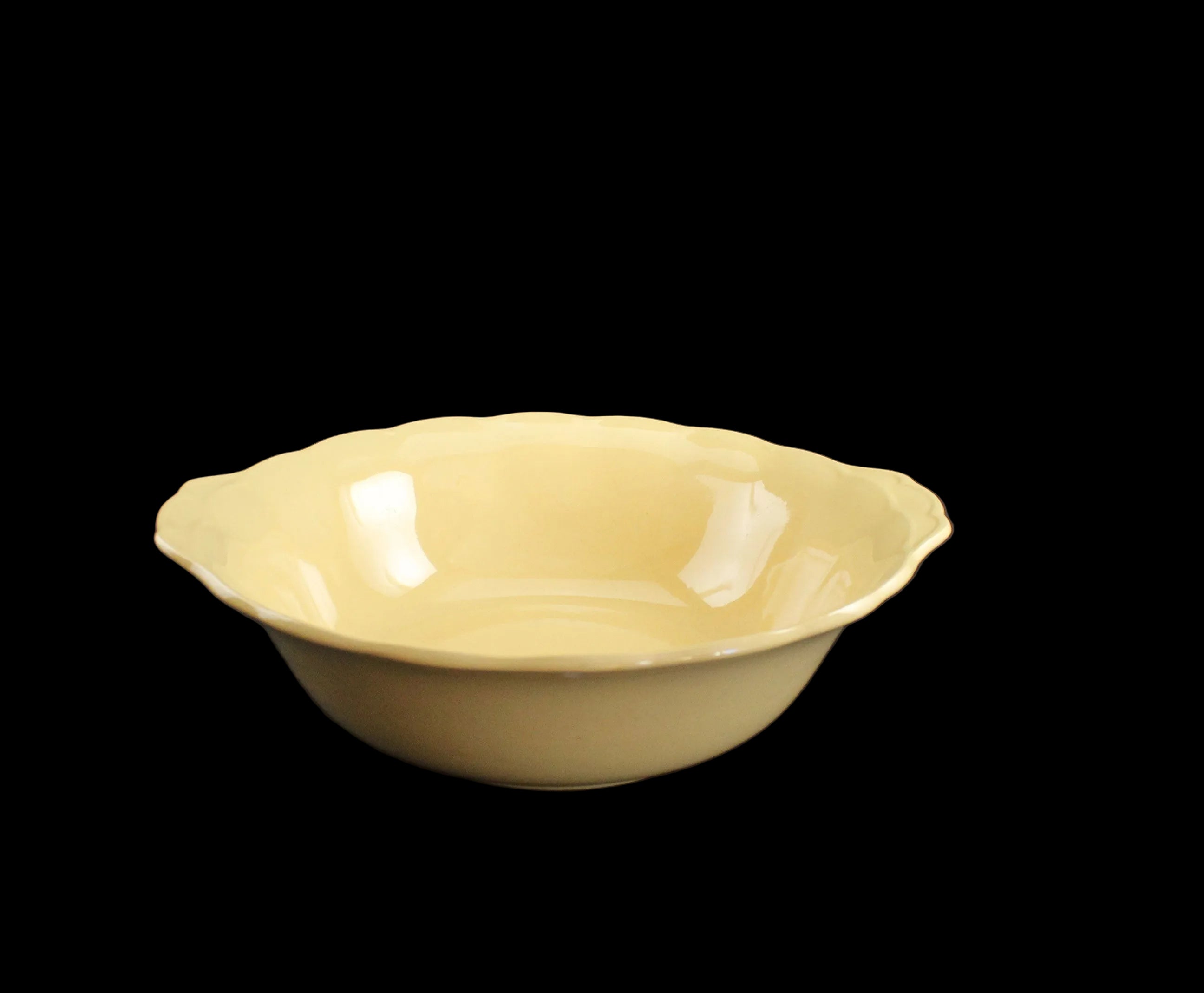 Yellow ceramic bowl on a black background