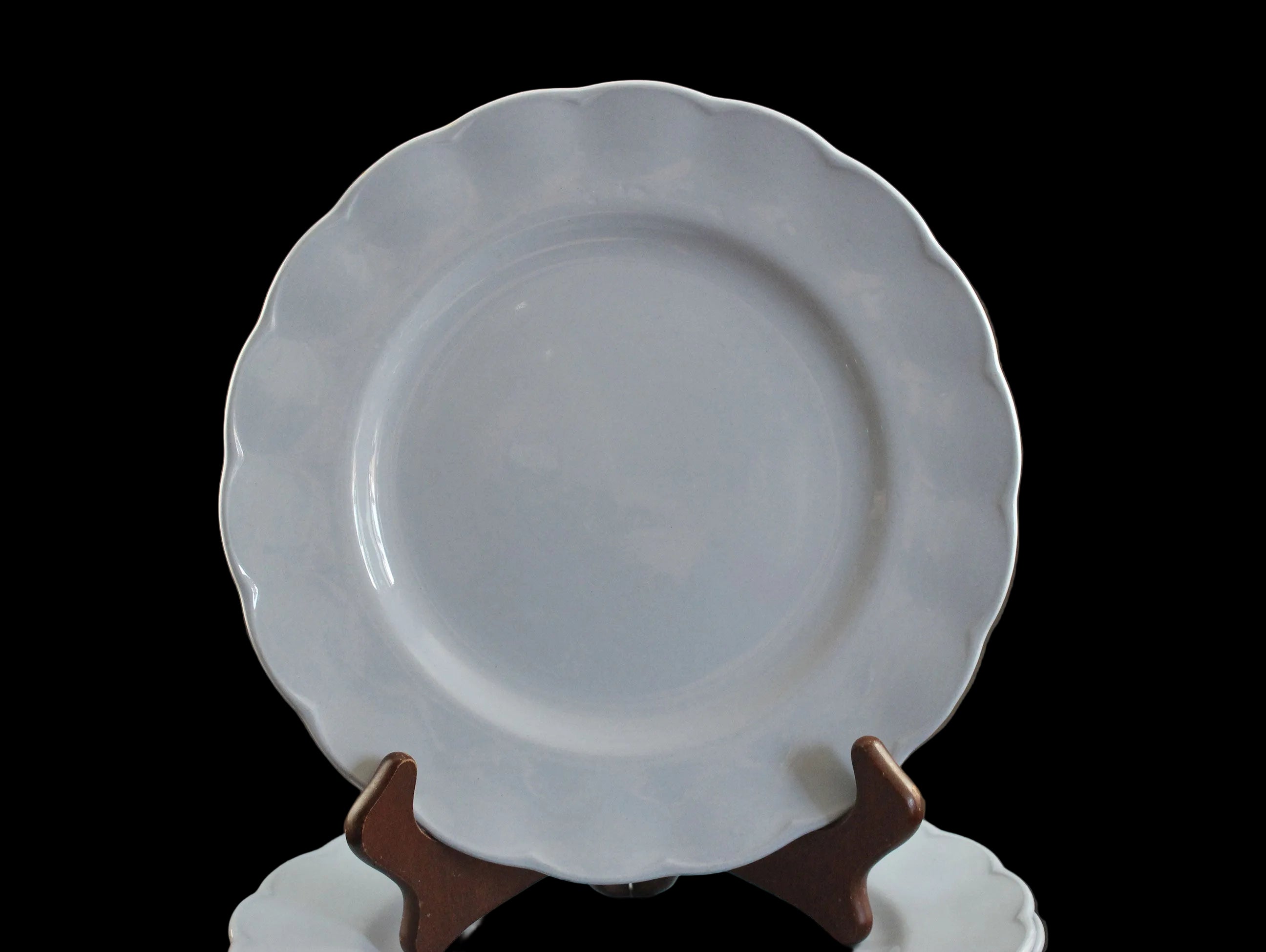 Set of light blue ceramic plates on a black background