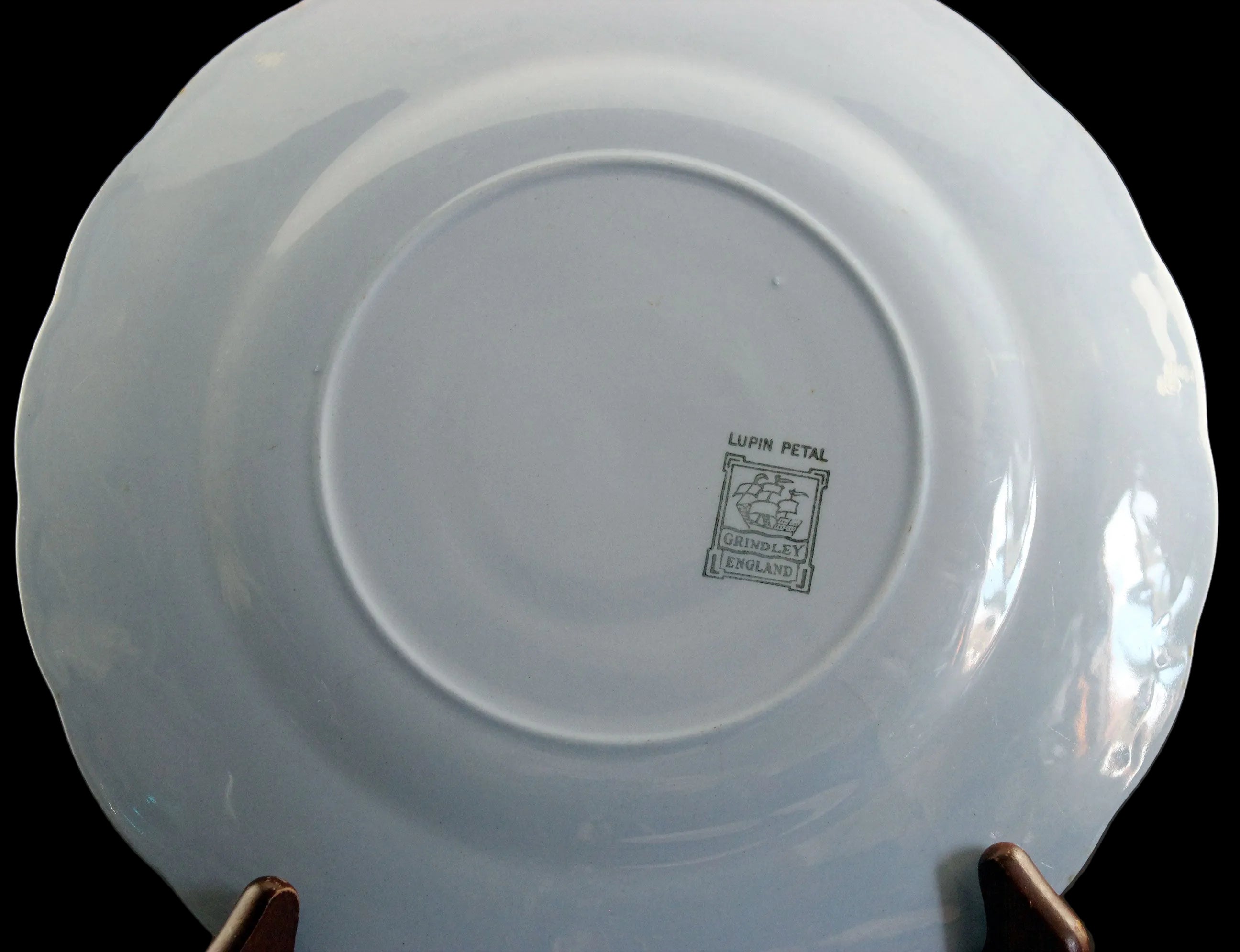 Set of light blue ceramic plates on a black background