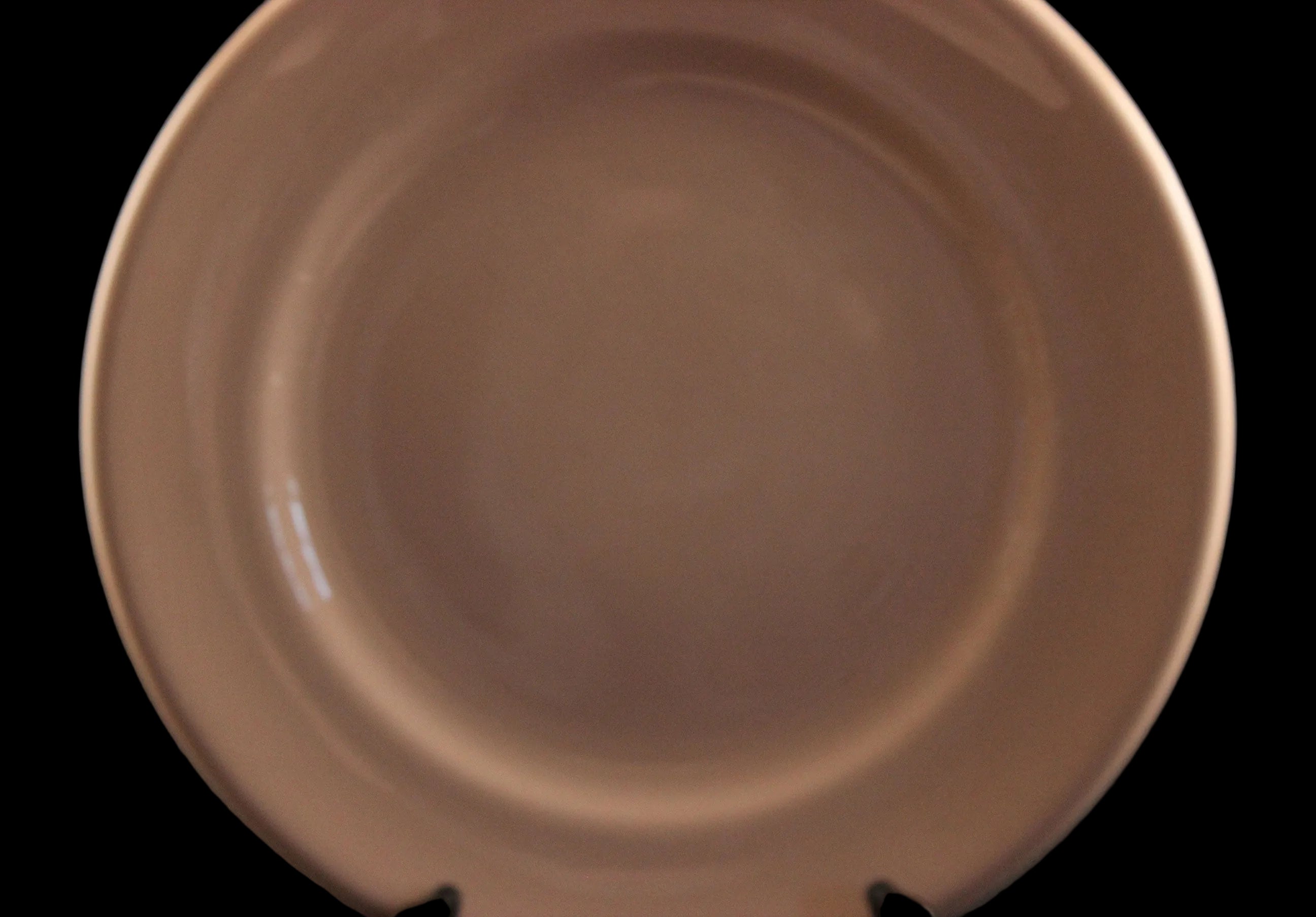 Pink ceramic plate on a dark background