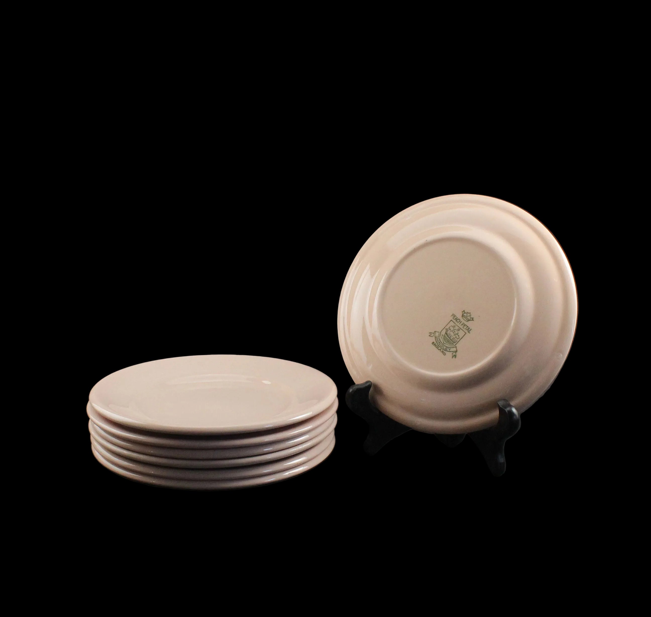 Set of ceramic plates with a logo on a dark background