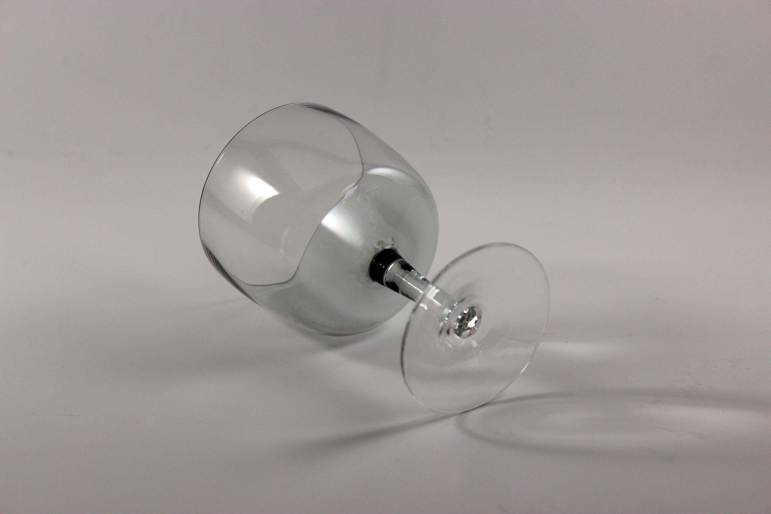 Set of smoked glass port glasses on a white background