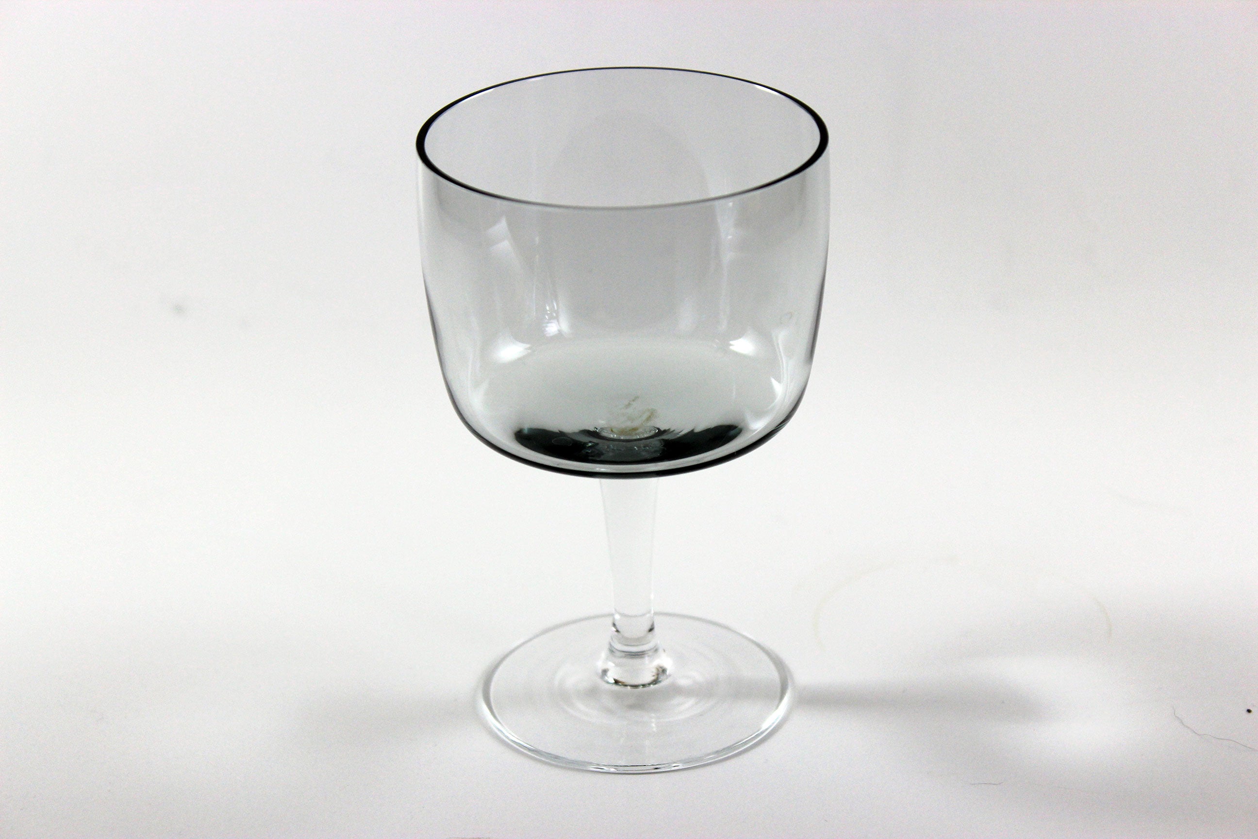 Set of smoked glass port glasses on a white background
