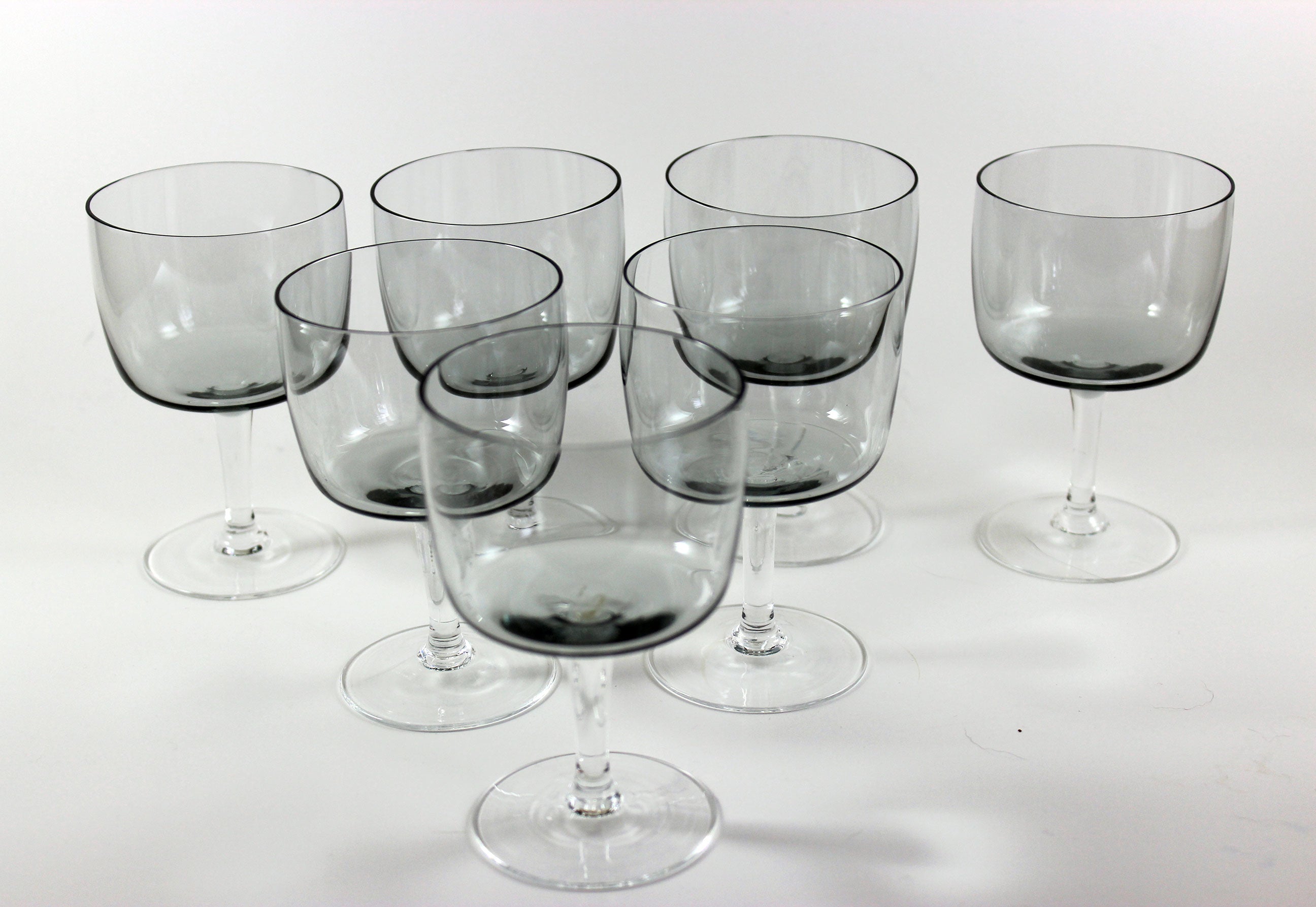 Set of smoked glass wine glasses on a white background