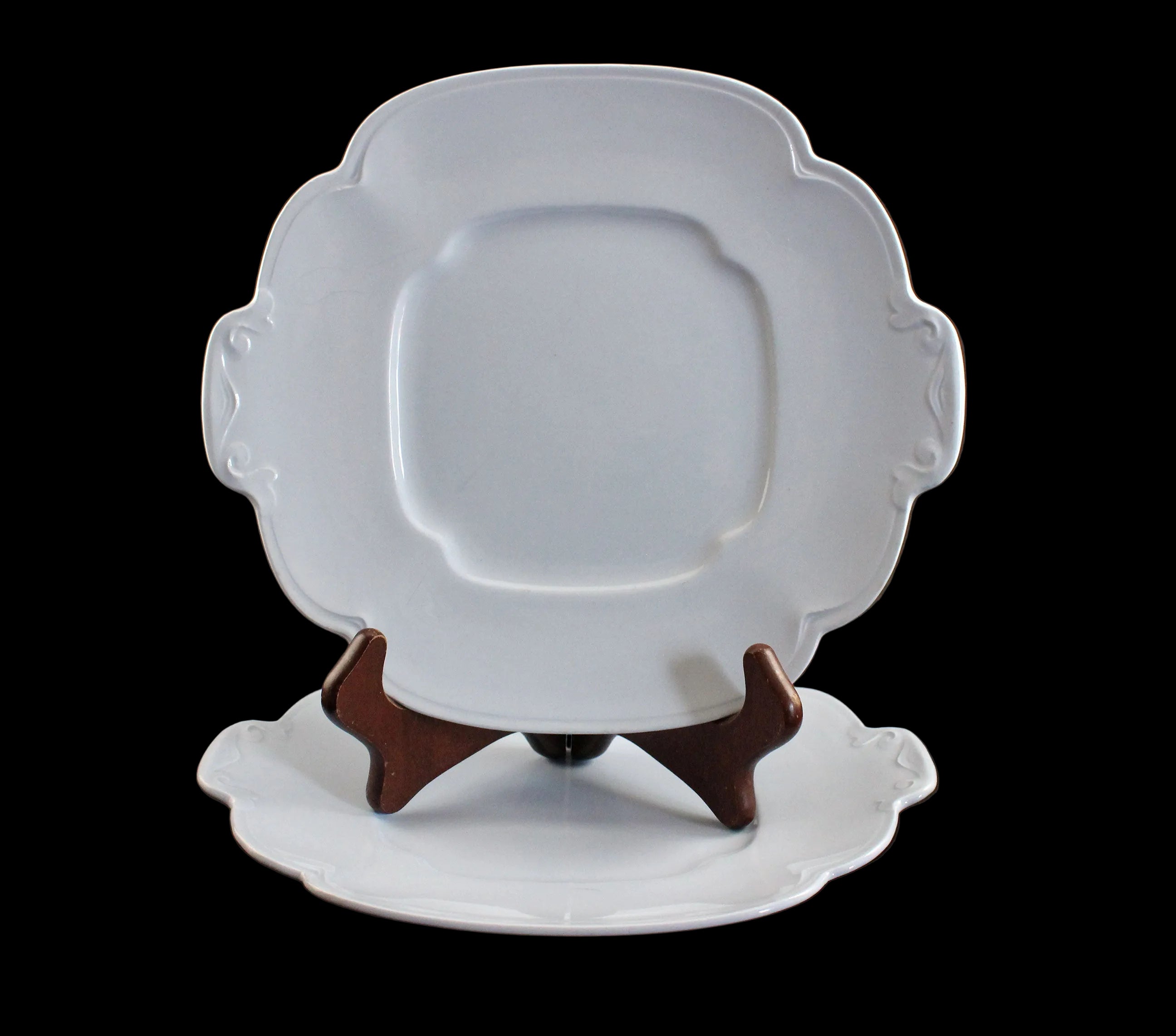 Light blue ceramic cake plate on black background.