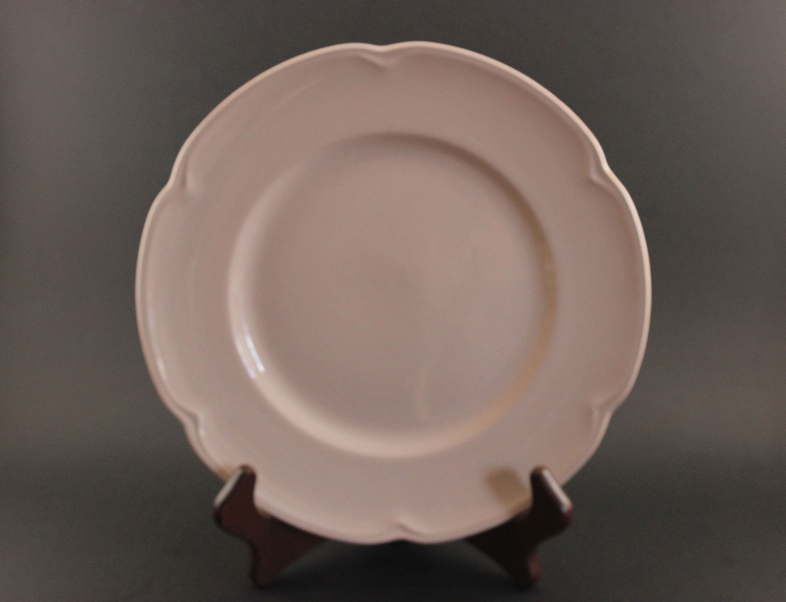Pink ceramic petalware plate on a dark gray background