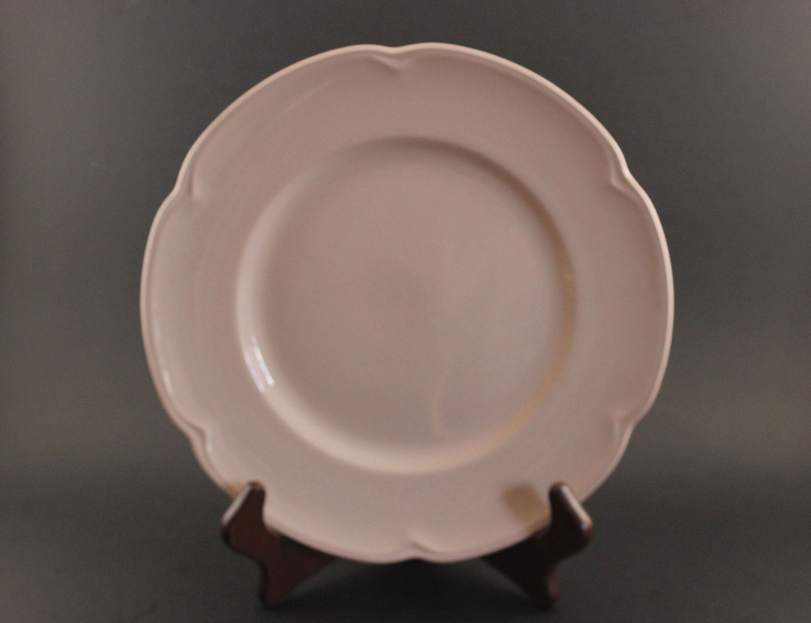 Pink ceramic petalware plate on a dark gray background