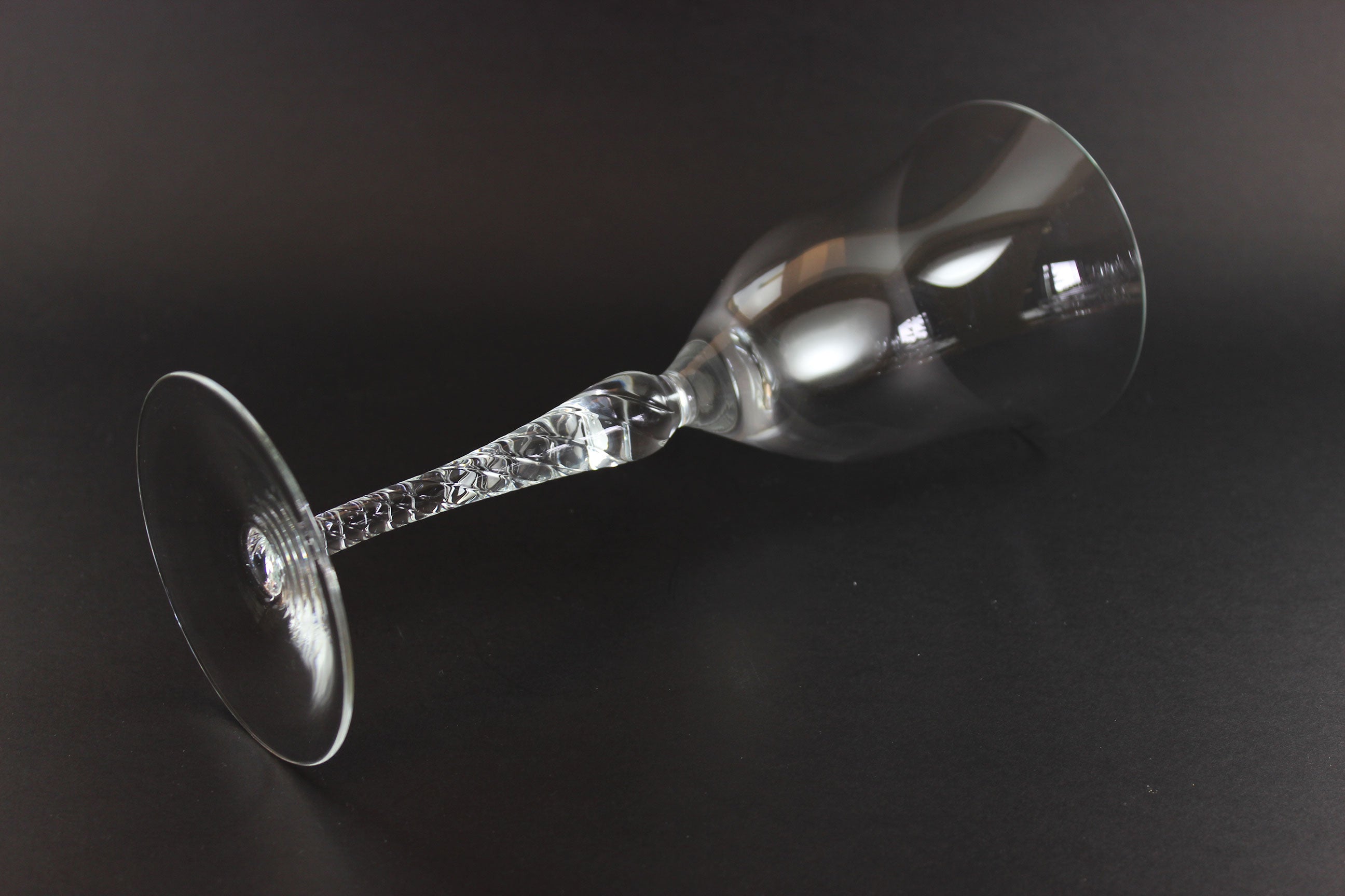 Clear glass wine glass on a black background