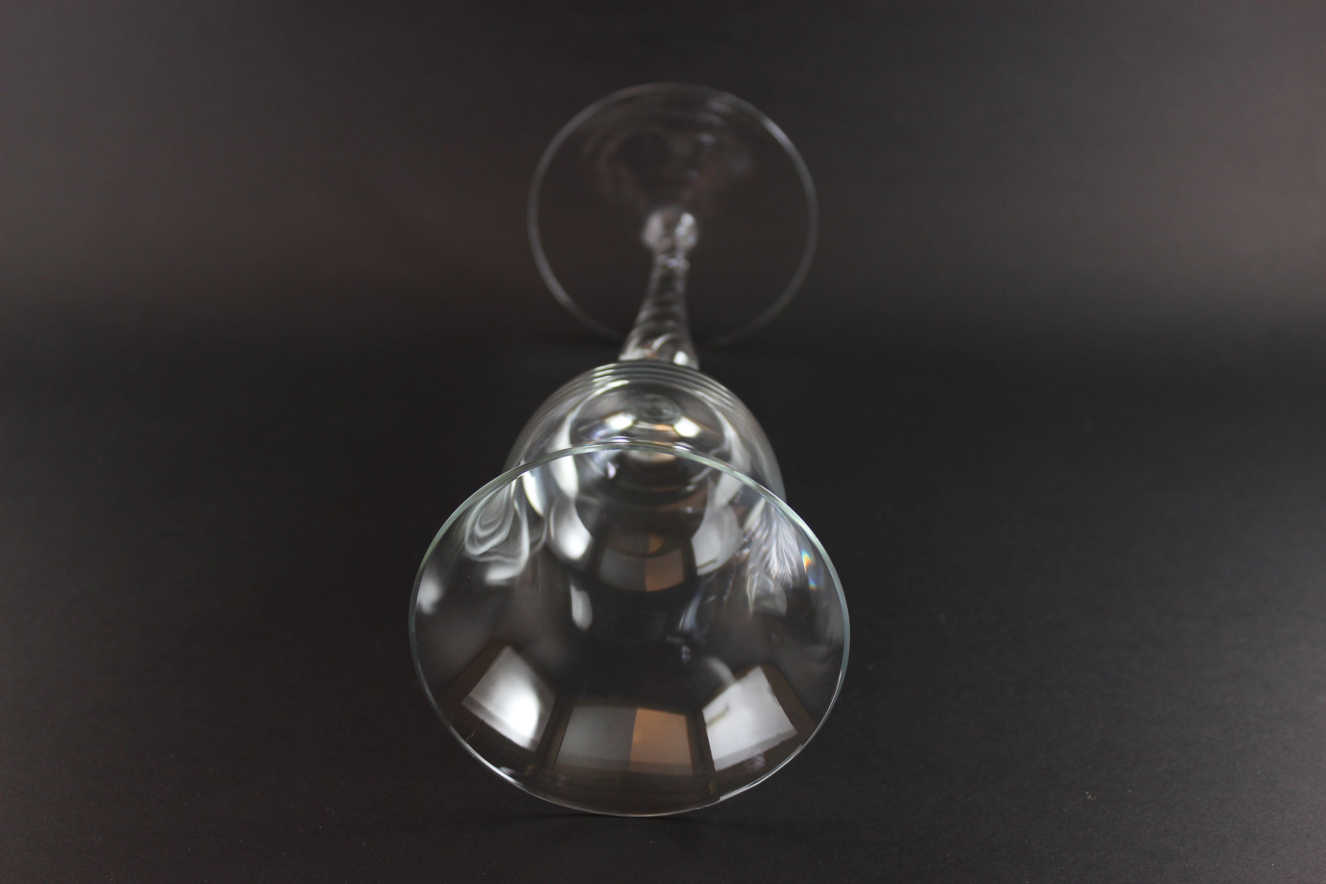 Clear glass wine glass on a black background