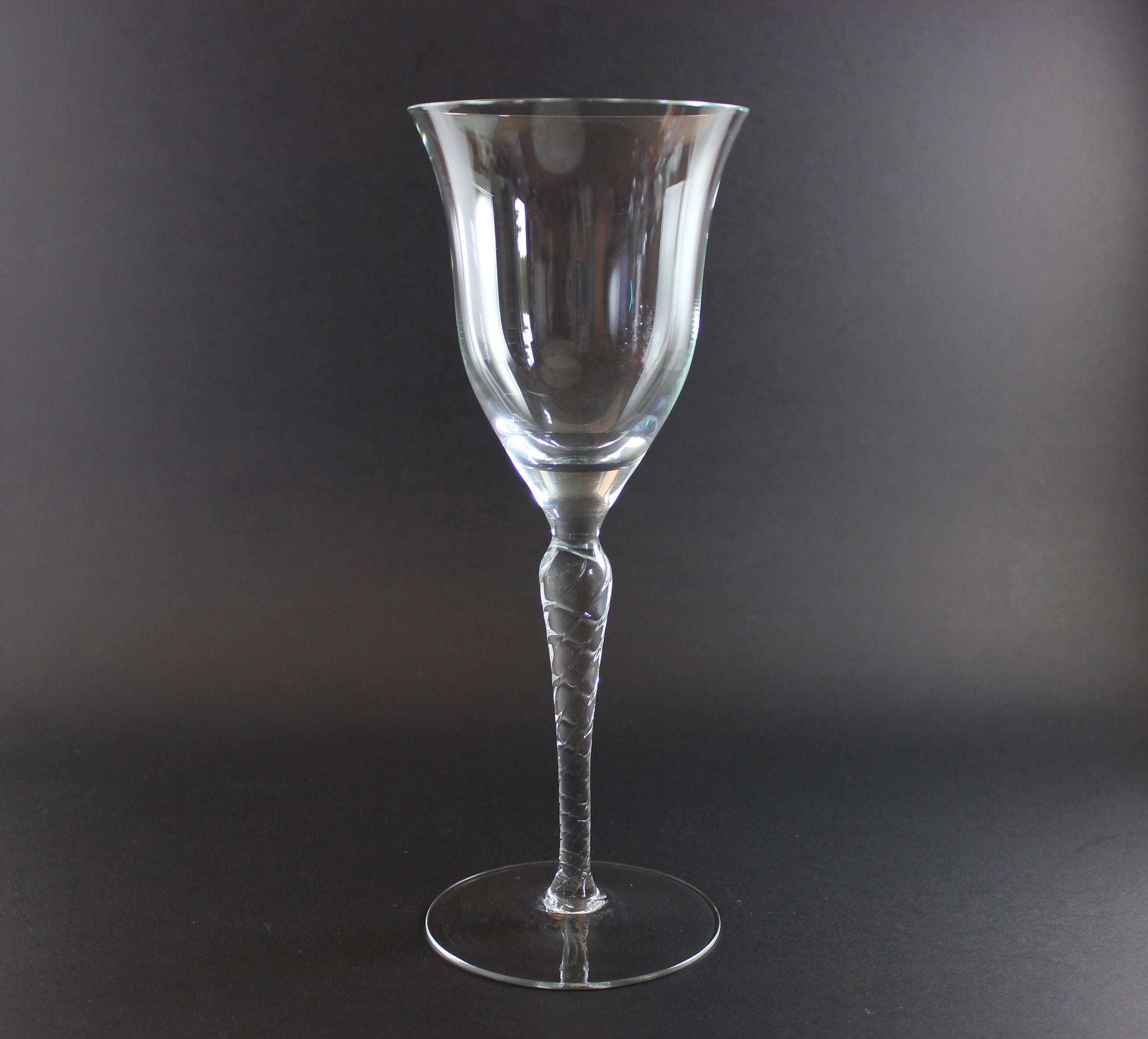 Clear glass wine glass on a black background