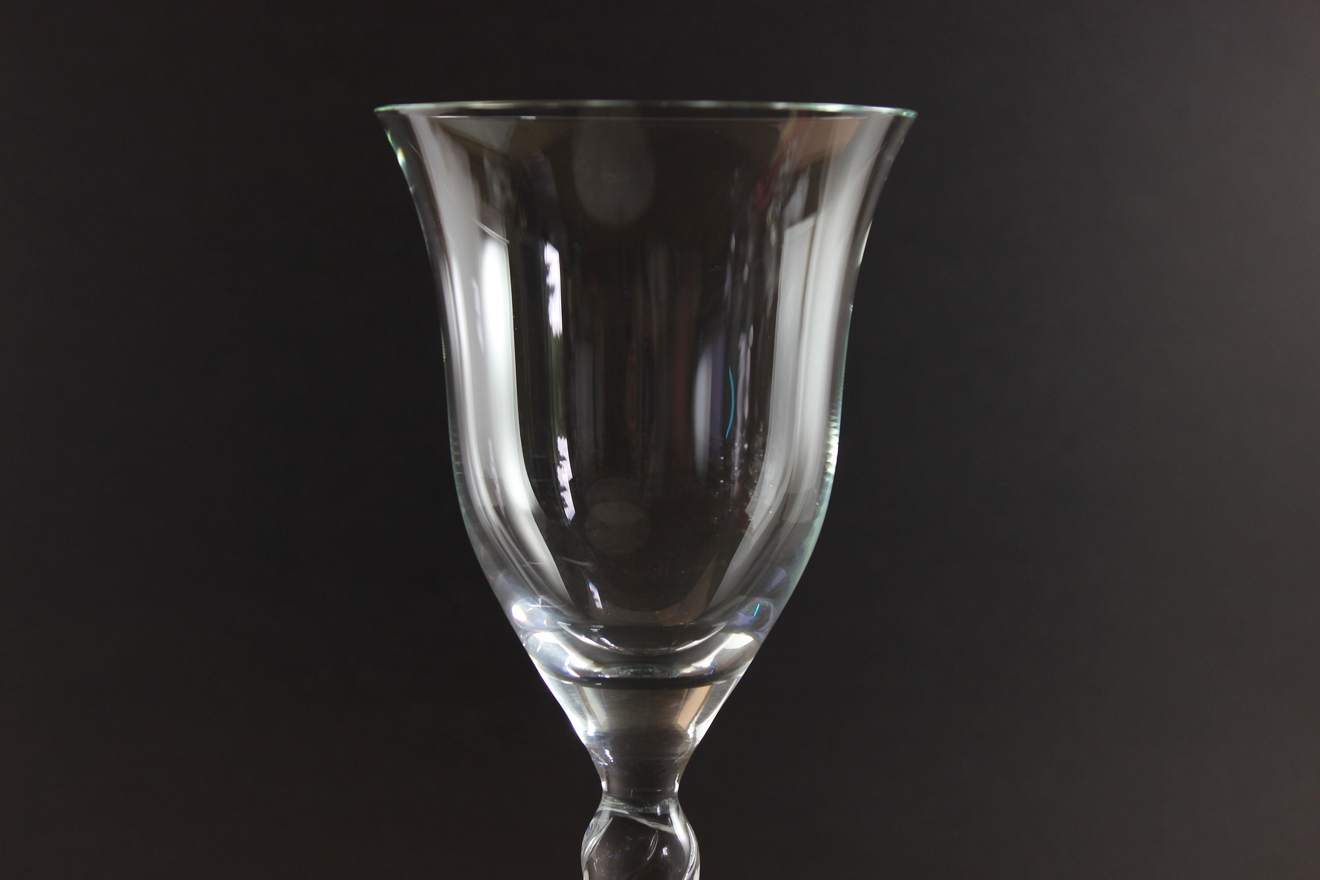 Clear glass goblet on a black background