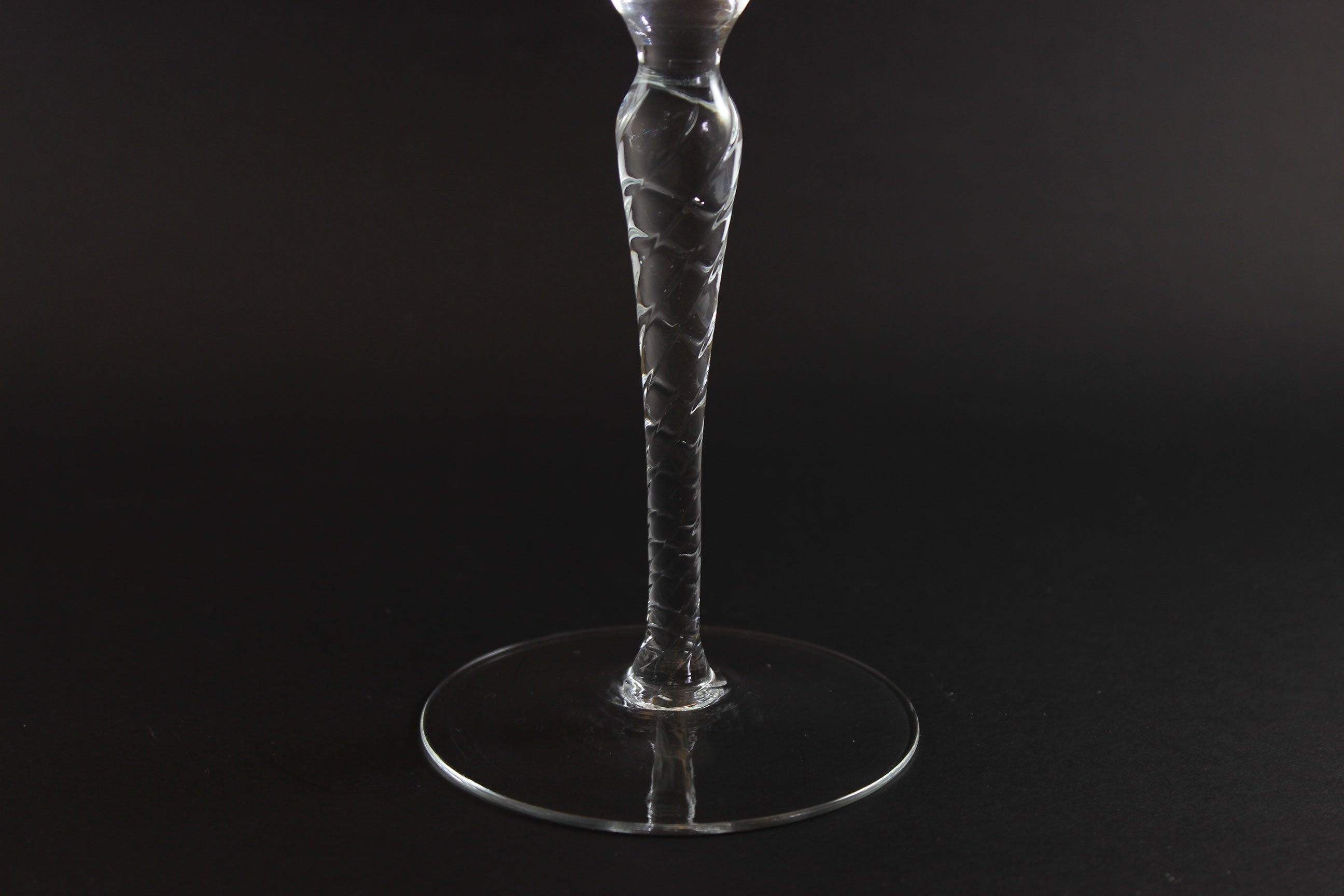Clear glass wine glass on a black background