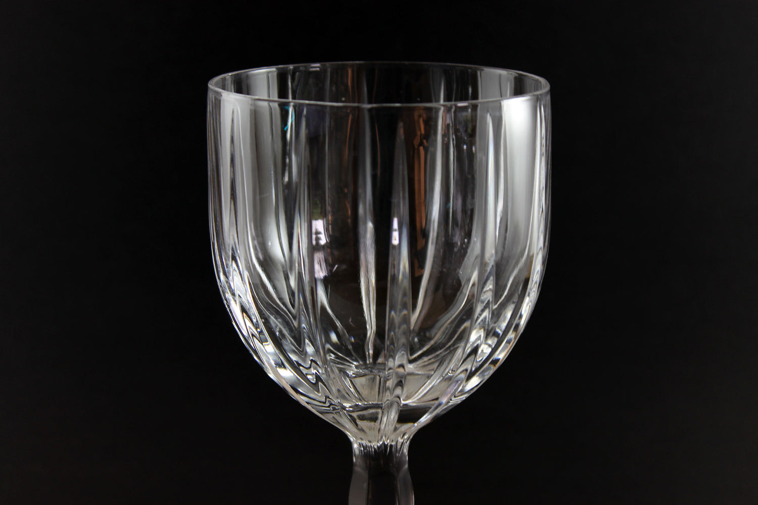 Clear glass goblet on a black background