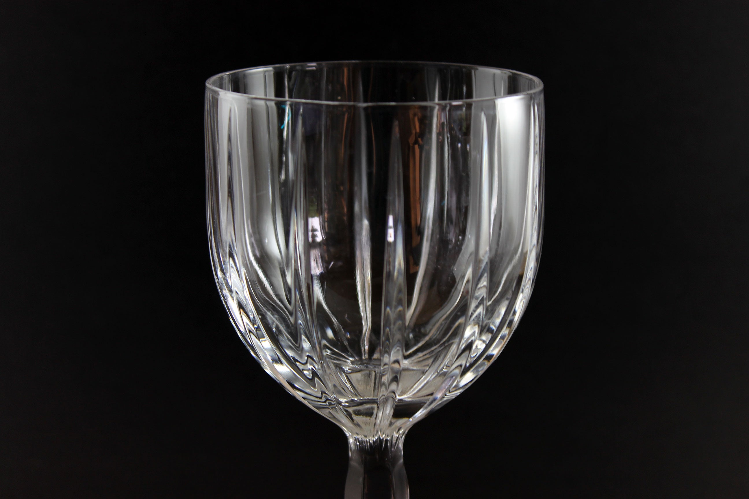 Clear glass goblet on a black background