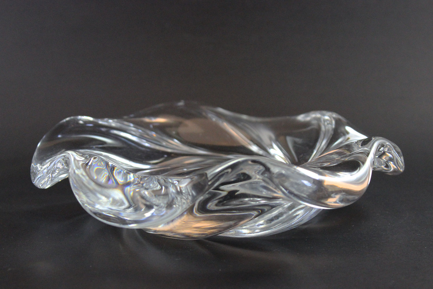 Clear crystal bowl with wavy design on a black background
