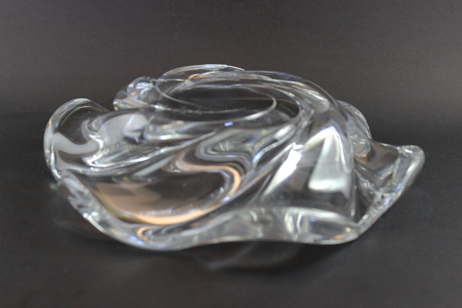 Clear crystal bowl with wavy design on a black background