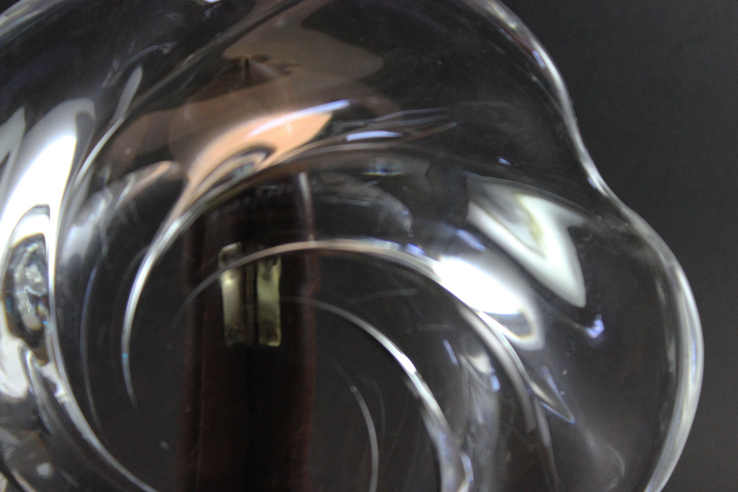 Clear crystal bowl with wavy design on a black background