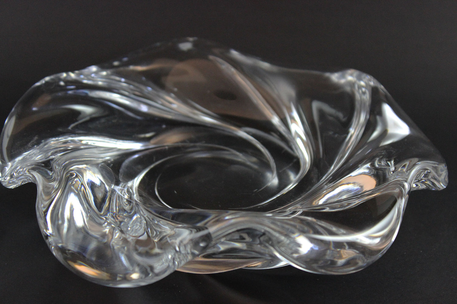 Clear crystal bowl with wavy design on a black background