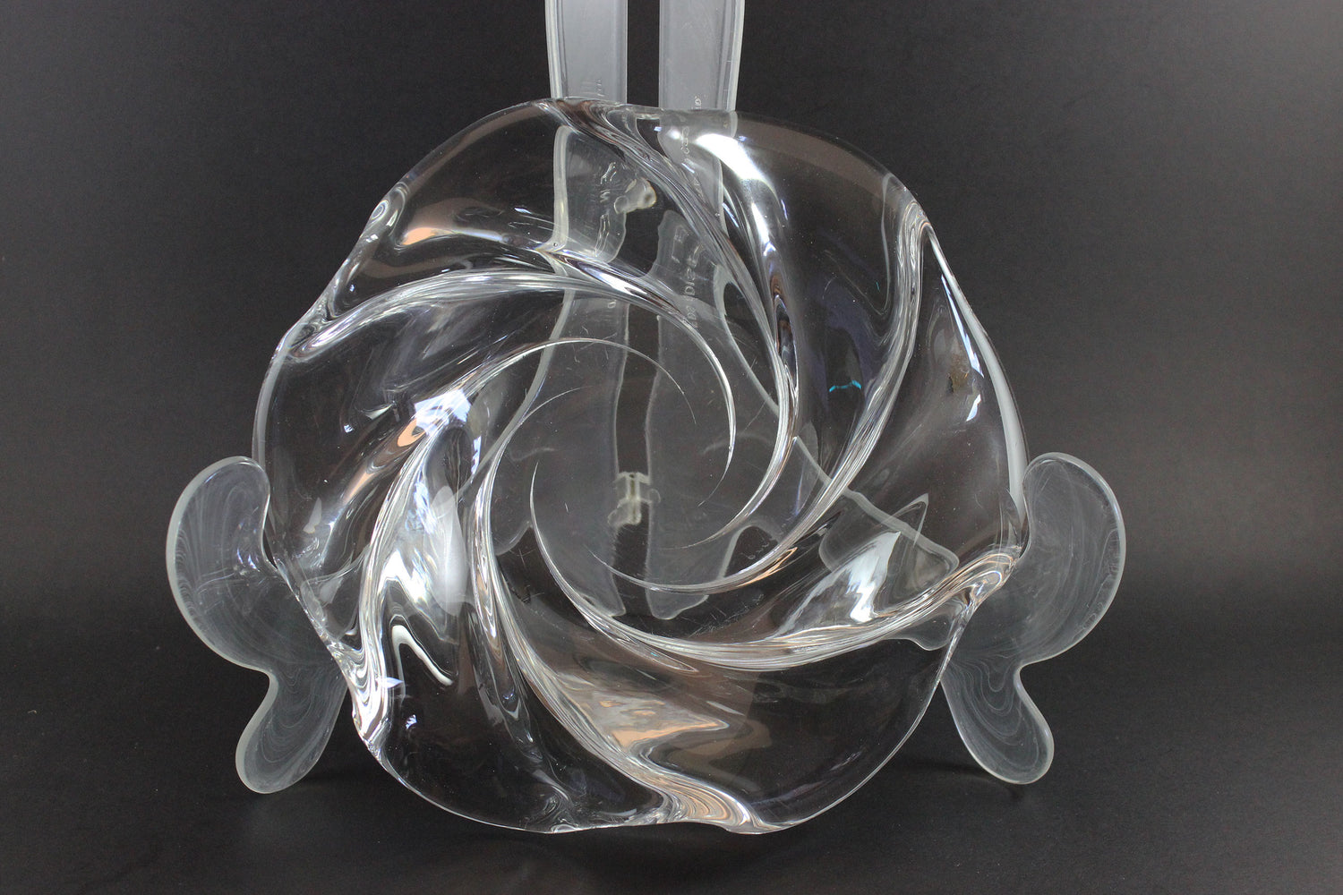 Clear crystal bowl with wavy design on a black background