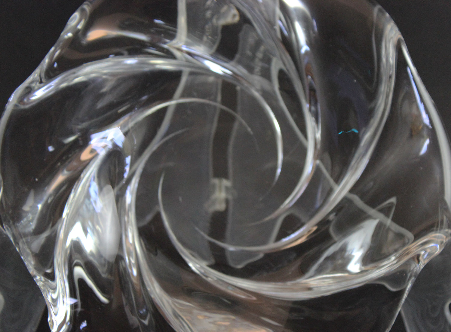 Clear crystal bowl with wavy design on a black background